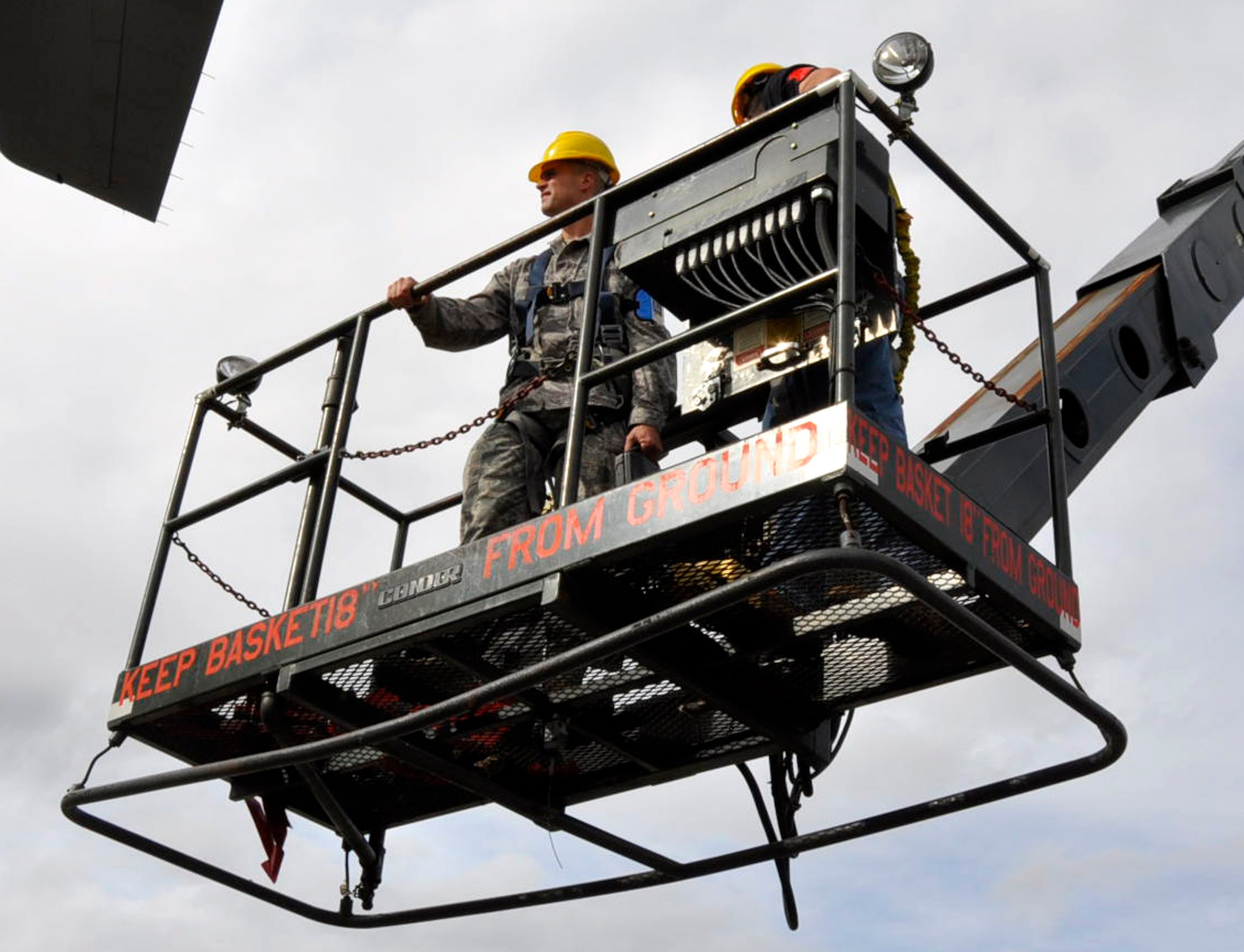 Air Force Airman 1st Class Joel Adriance, 446th Aircraft Maintenance Squadron hydaulic systems apprentice out of McChord Field, Wash., takes a ride in a Condor maintenance platform basket in order to place external locks on a C-17 Globemaster III rudder, Sept. 22, 2011. Adriance is also a high school math teacher in Coupeville, Wash. He joined because he felt the need to serve. "I always felt that every citizen who has the benefit of protection by the U.S. military should attempt to contribute in some way," he said.  (U.S. Air Force photo by Master Sgt. Jake Chappelle)