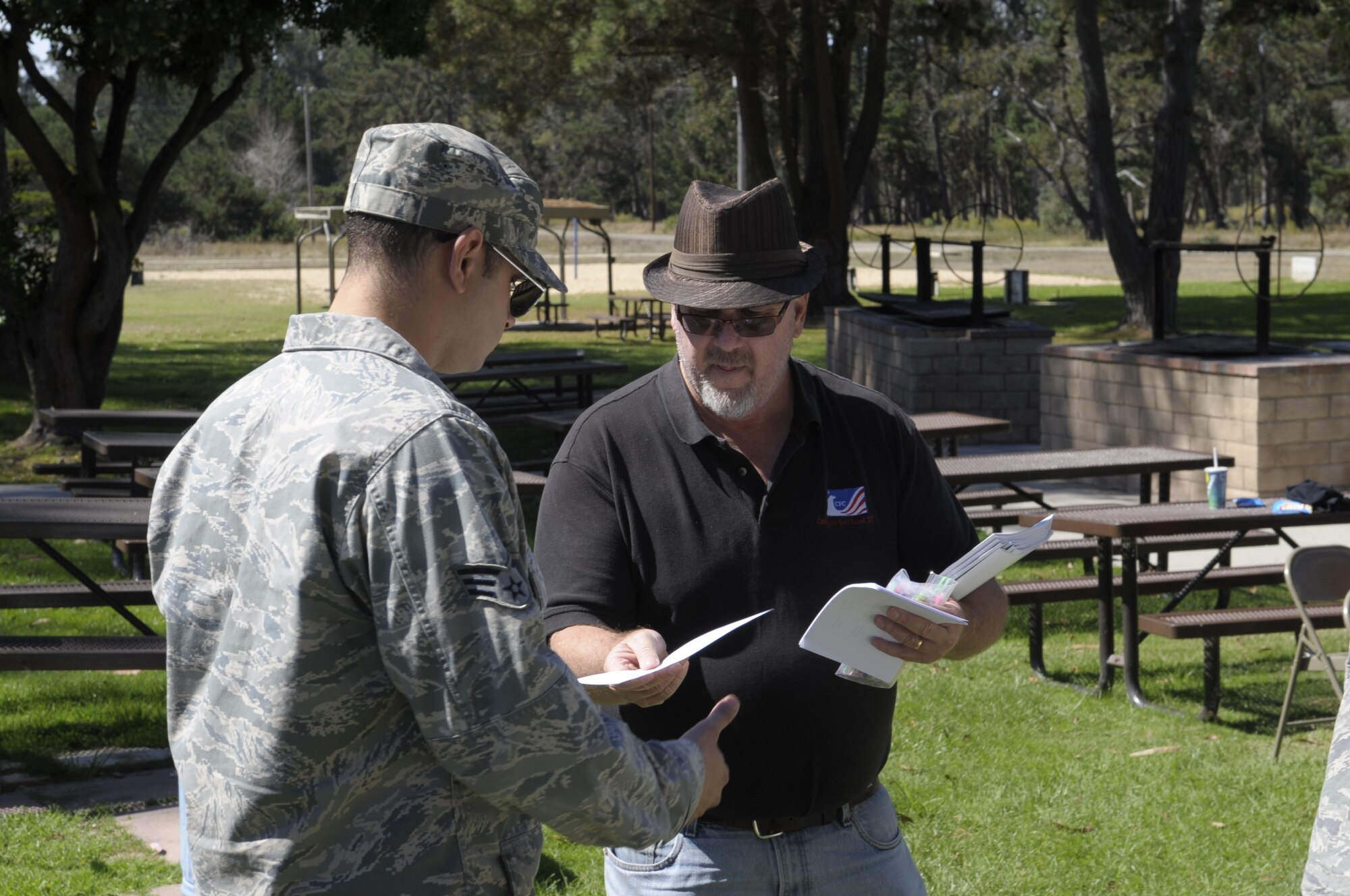 VANDENBERG AIR FORCE BASE, Calif. -- George Smith, California Gold Coast Combined Federal Campaign assistant director, hands out sign-in sheets to Team Vandenberg members at an ice cream social held at Cocheo Park here Monday, Oct. 3, 2011.  The California Gold Coast Combined Federal Campaign hosted a free ice cream social to provide information about this year’s campaign.
(U.S. Air Force photo/Jerry E. Clemens, Jr.)