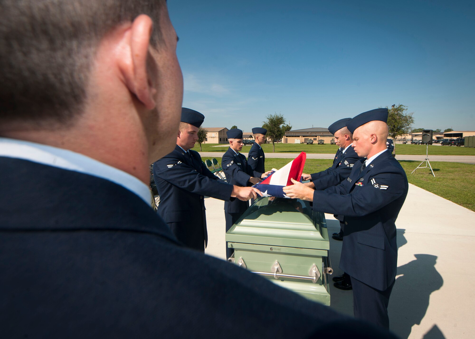 Moody Air Force Base Honor Guard members begin the folding of the American flag during a military honors demonstration at Moody AFB, Ga., Sept. 30, 2011. Team Moody’s honor guard went through training with U.S. Air Force Honor Guard members who visited the base for two weeks to share their knowledge. (U.S. Air Force photo by Airman 1st Class Joshua Green/Released) 
