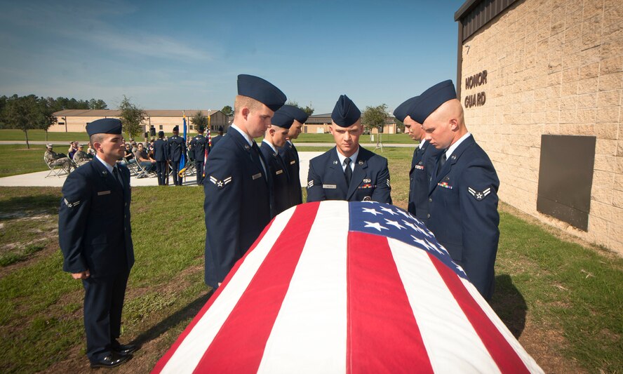 U.S. Air Force Senior Airman Gary Wilder, Moody Air Force Base Honor Guard member, center, pulls a casket off of a rack during the start of a military honors demonstration at Moody AFB, Ga., Sept. 30, 2011.  During their two-week training with the U.S. Air Force Honor Guard, Moody’s honor guard team brushed up on proper techniques to standardize their ceremony procedures with those across the Air Force. (U.S. Air Force photo by Airman 1st Class Joshua Green/Released)
