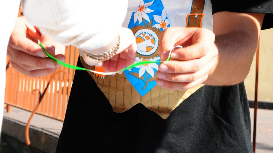 2nd Lt. Corey Lohmiller, 2nd Civil Engineer Squadron, puts a green bracelet on an Oktoberfest attendee's wrist on Barksdale Air Force Base, La., Sept. 30. ID checks were conducted for green-bracelets to ensure a person was over 21 and Airmen Against Drunk Driving were present to ensure event attendees had a safe, enjoyable evening. (U.S. Air Force photo/Airman 1st Class Benjamin Gonsier)(RELEASED)