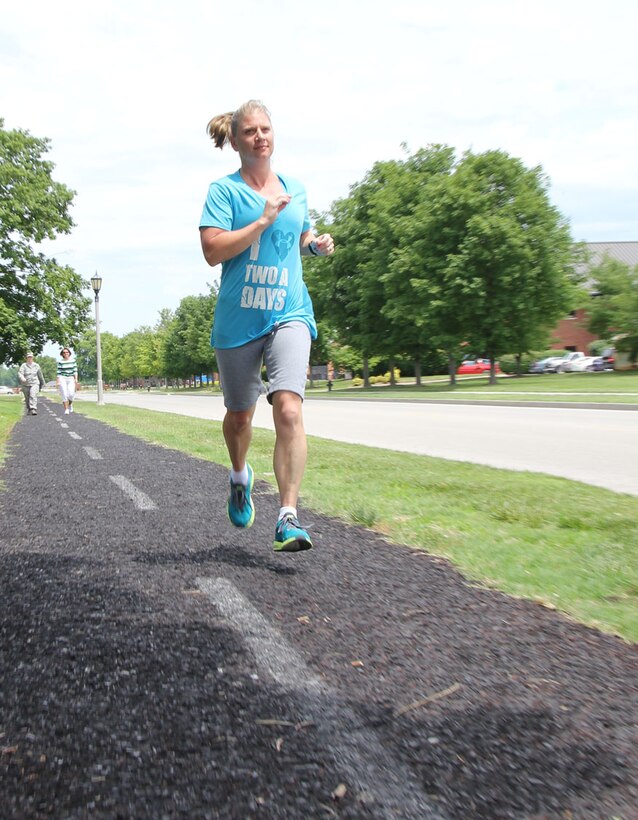 Master Sgt. Cynthia Umschied gets "air time" with both feet off the ground during a noon workout at Scott Air Force Base in Illinois.  Umschied went from failing her fitness test at one point, to getting serious and working out harder and more consistently.  Umschied now passes the fitness test with confidence.  She is one of the 932nd Airlift Wing members actively promoting fitness throughout the wing.  (U.S. Air Force photo/Maj. Stan Paregien)