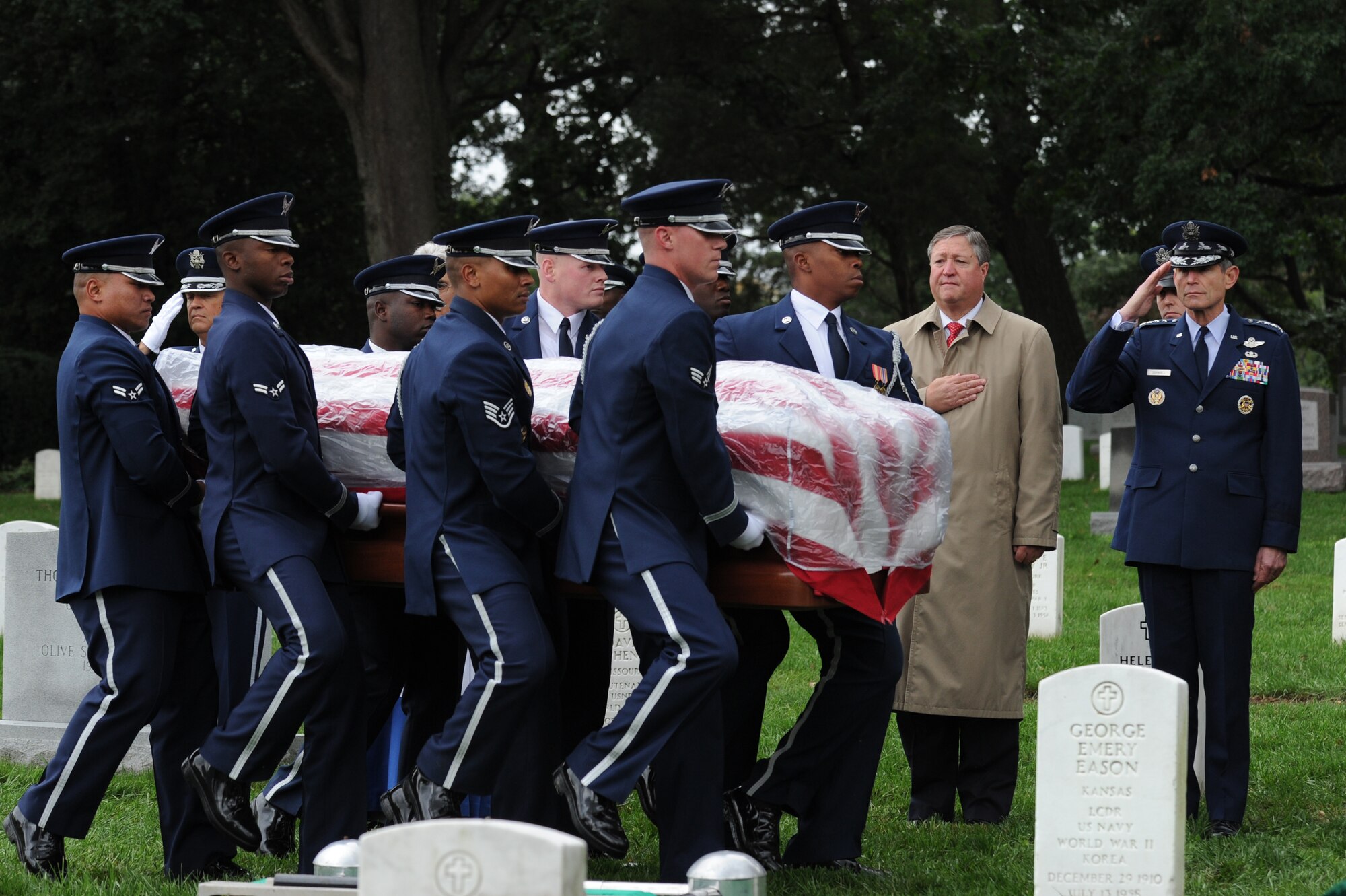 U.S. Air Force Honor Guard members carry retired Maj. Gen. John Alison to his final resting place as Secretary of the Air Force Michael Donley and Air Force Chief of Staff Gen. Norton Schwartz look on Oct. 3, 2011, at Arlington National Cemetery, Va. Donley and Schwartz were present at the full-honors funeral to pay their respects to Alison, a World War II and Korean War hero, and his family. (U.S. Air Force photo/Staff Sgt. Christopher Ruano)