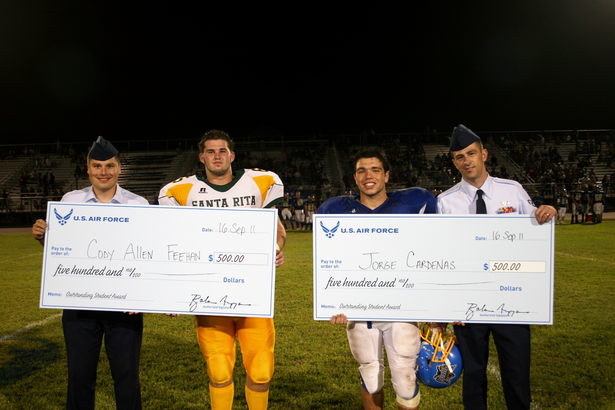 (l-r) Staff Sgt. Kevin Farr, 362nd RCS recruiter; Cody Feehan, Santa Rita high school senior; Jorge Cardenas, Palo Verde high school senior; and Staff Sgt. Benjamin Menez, 362nd RCS recruiter. The 362nd Recruiting Squadron presented $500 scholarships to the two local high school athletes as part of the squadron’s first Air Force Invitational event in Tucson, Ariz., Sept. 16. (U.S. Air Force photo/Tech. Sgt. April Silveira)