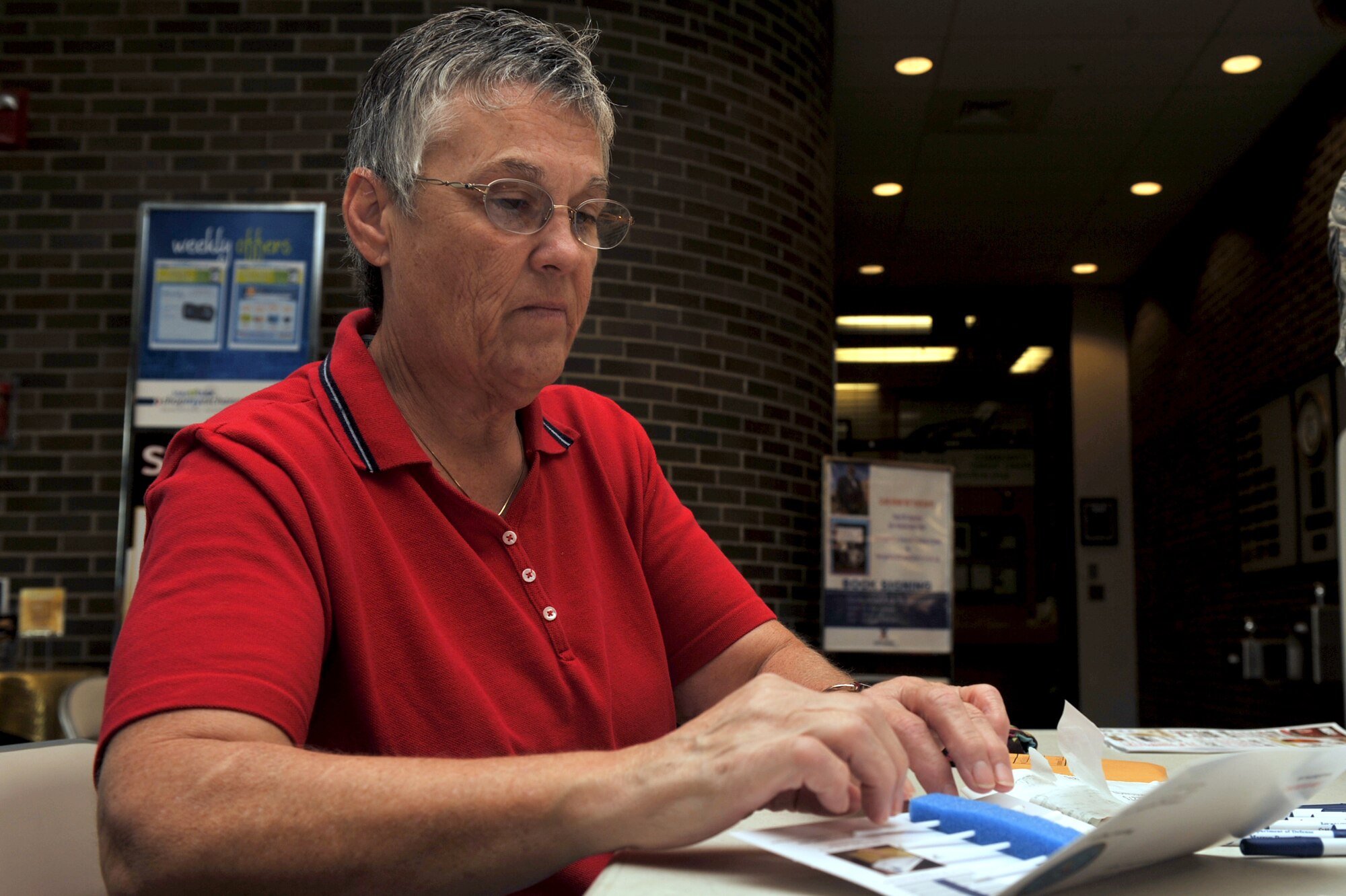 Bonny Jones completes a Buccal swab collection kit during a bone marrow drive at Seymour Johnson Air Force Base, N.C., Sept. 30, 2011. Members of the 4th Medical Group set up tables at the Xchange and Commissary to ask shoppers to participate in a bone marrow drive, searching for a donor match for an Army sergeant's daughter who is fighting leukemia. (U.S. Air Force photo by Senior Airman Whitney Stanfield)