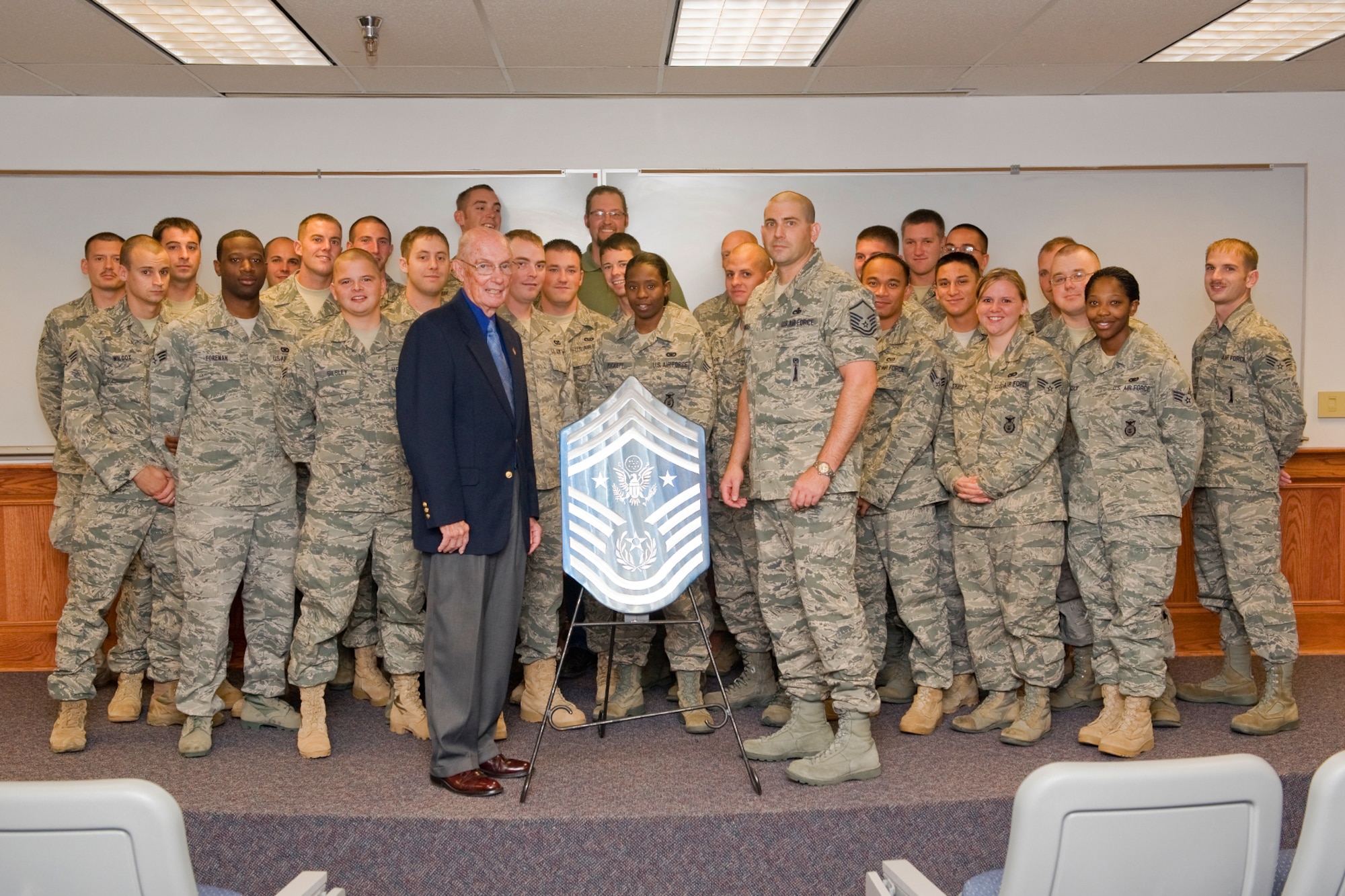 Retired Chief Master Sgt. of the Air Force James McCoy poses with the Commandant of Airman Leadership School Master Sgt. Kirk McManious, and the members of ALS Class 11-G Sept. 27. McCoy was the guest speaker at the graduation ceremony that evening. (U.S. Air Force photo/Beau Wade)