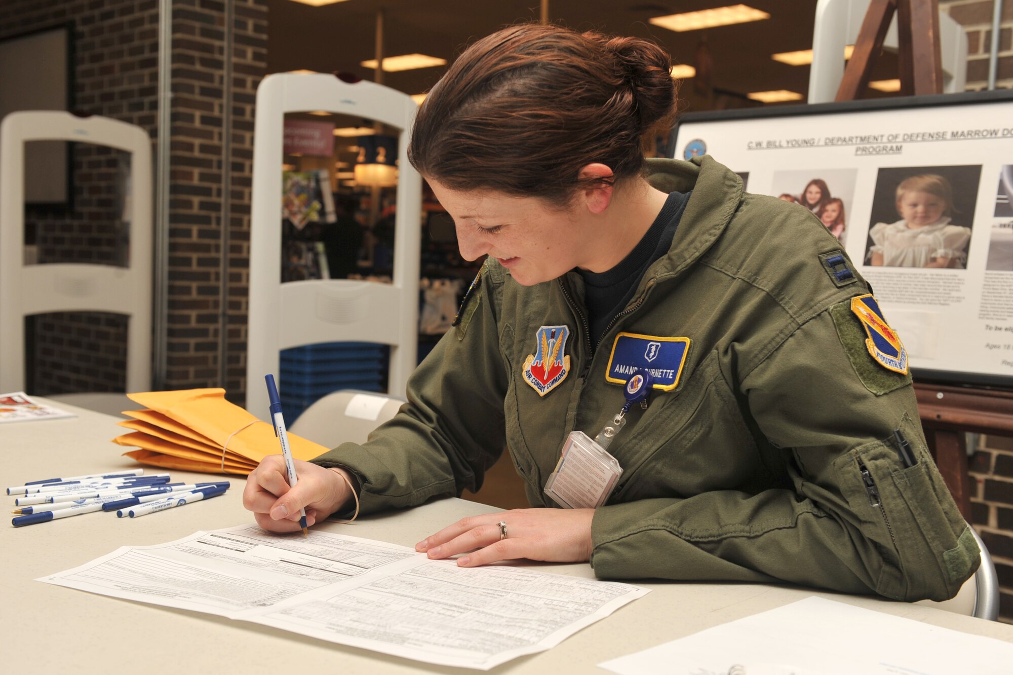 Capt. Amanda Burnette approves an applicant bone marrow consent form during a bone marrow drive at Seymour Johnson Air Force Base, N.C., Sept. 30, 2011. Representatives have to sign off consent forms after reviewed for accuracy.  Burnette is a 4th Medical Operations Squadron aerospace and operational physiology training officer in charge and a native of York, Penn. (U.S. Air Force photo by Senior Airman Whitney Stanfield)