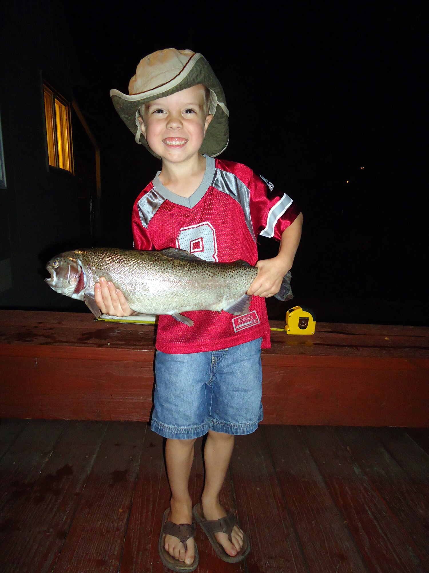 Logan Gates, 4, proudly shows off the fish he caught from Pow Wow park pond Sept 24. He landed the 5 pound, 21 inch rainbow trout with his Batman fishing pole using worms and bobbers. Logan is the son of Tech. Sgt. James Gates, 16th Munitions Squadron ground safety officer. (Courtesy photo)