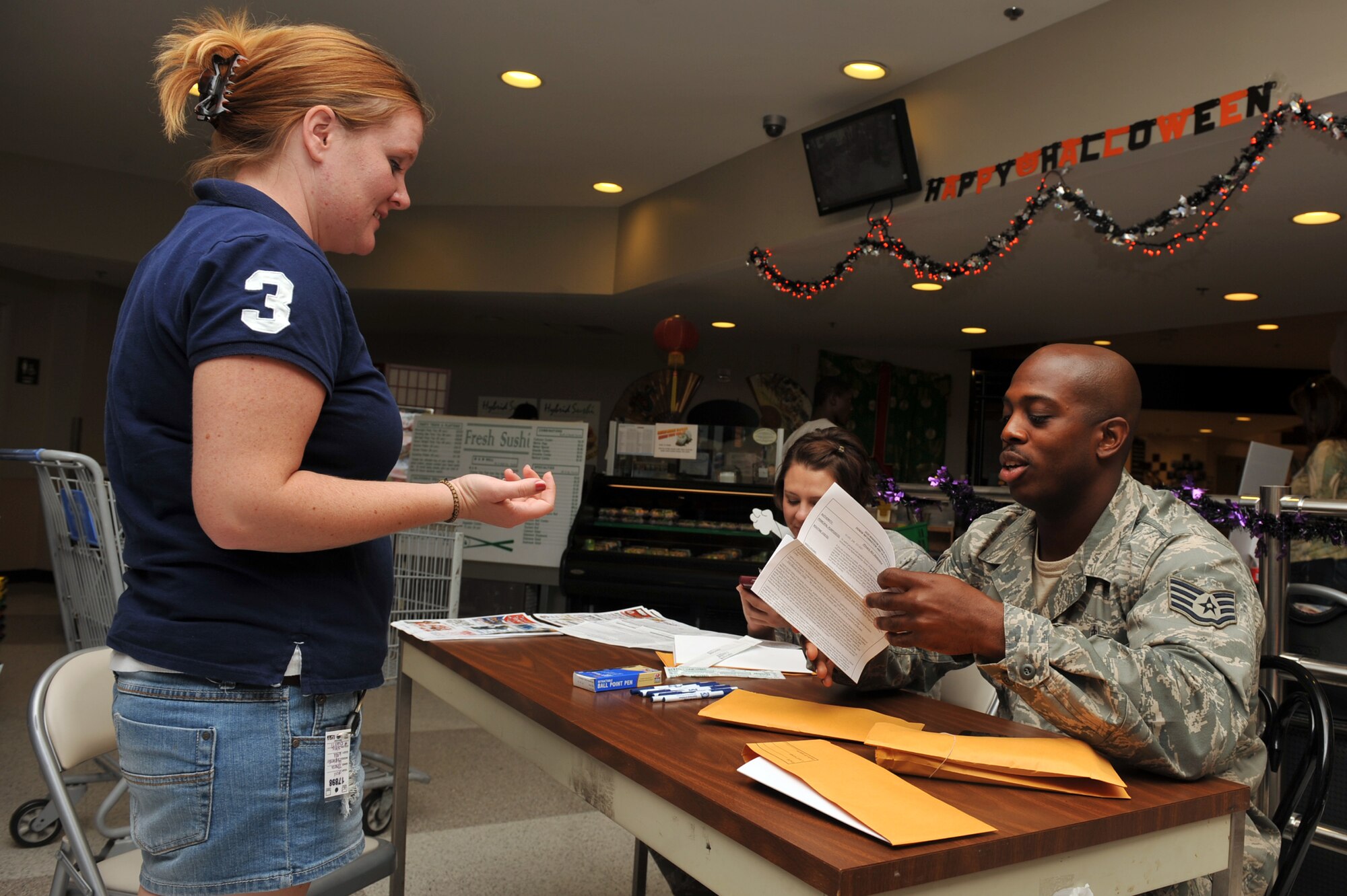 Staff Sgt. Marshall Jacobs speaks with Rye Blanks about participating in a bone marrow drive at Seymour Johnson Air Force Base, N.C., Sept. 30, 2011. Individuals registered, signed consent forms and were provided a Buccal swab collection kit to swab the inside of their mouth to determine their human leukocyte antigen type. Jacobs is a 4th Medical Operations Squadron aerospace and operational physiology training journeymen and a native of Hampton, Va. Blanks is a military spouse and a native of Tacoma, Wash. (U.S. Air Force photo by Senior Airman Whitney Stanfield)