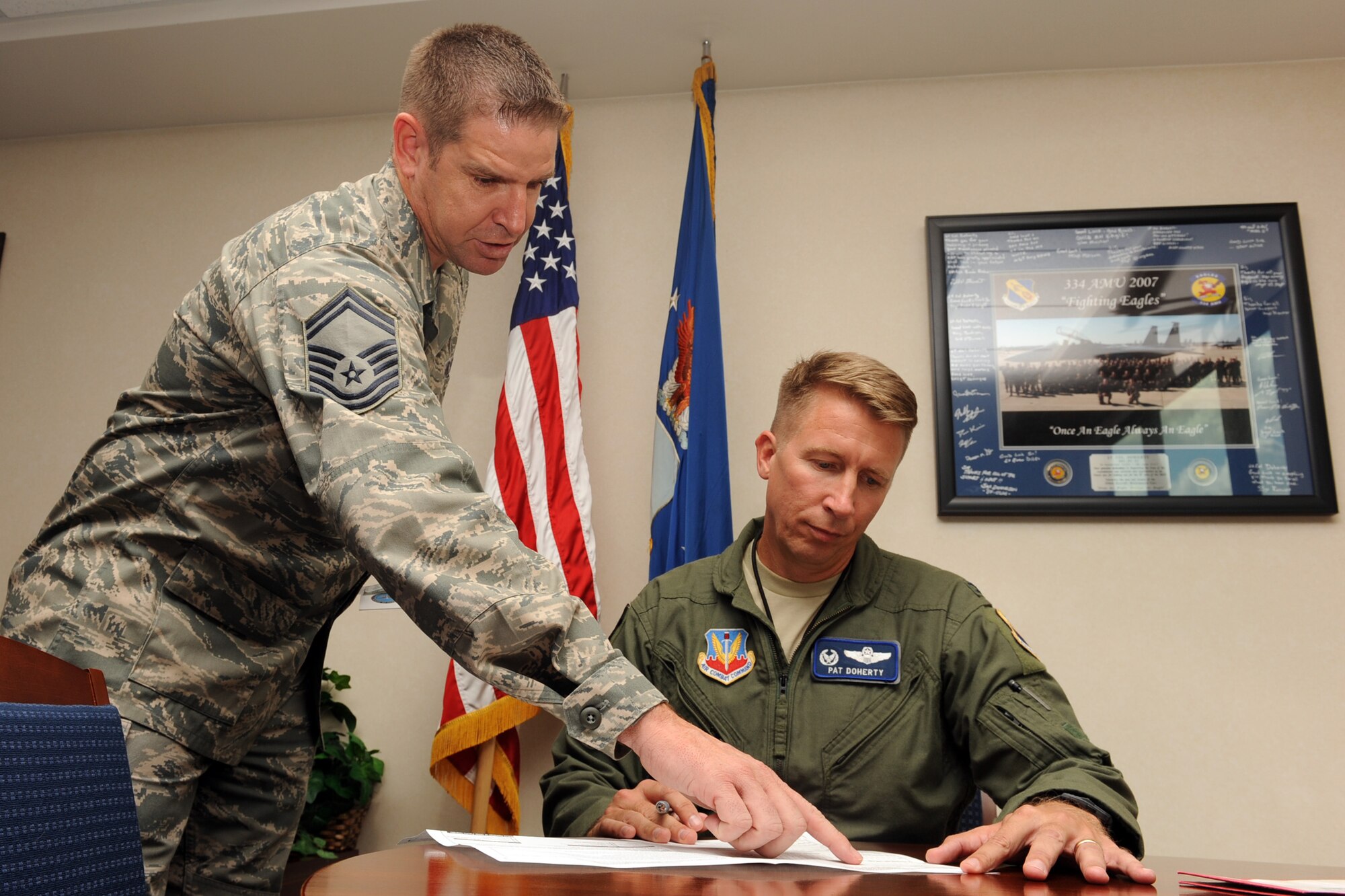 Senior Master Sgt. Michael Jenkins, 4th Medical Operations Squadron superintendant, reviews Colonel Patrick Doherty, 4th Fighter Wing (FW) commander, bone marrow consent form at Seymour Johnson Air Force Base, N.C., during bone marrow drive, Sept. 27, 2011. The bone marrow drive is searching for a donor match for an Army sergeant's daughter who is fighting leukemia. Doherty is a native of Lincoln, Neb. and Jenkins is a native of Lakeland, Fla. (U.S. Air Force photo by Senior Airman Whitney Stanfield) 