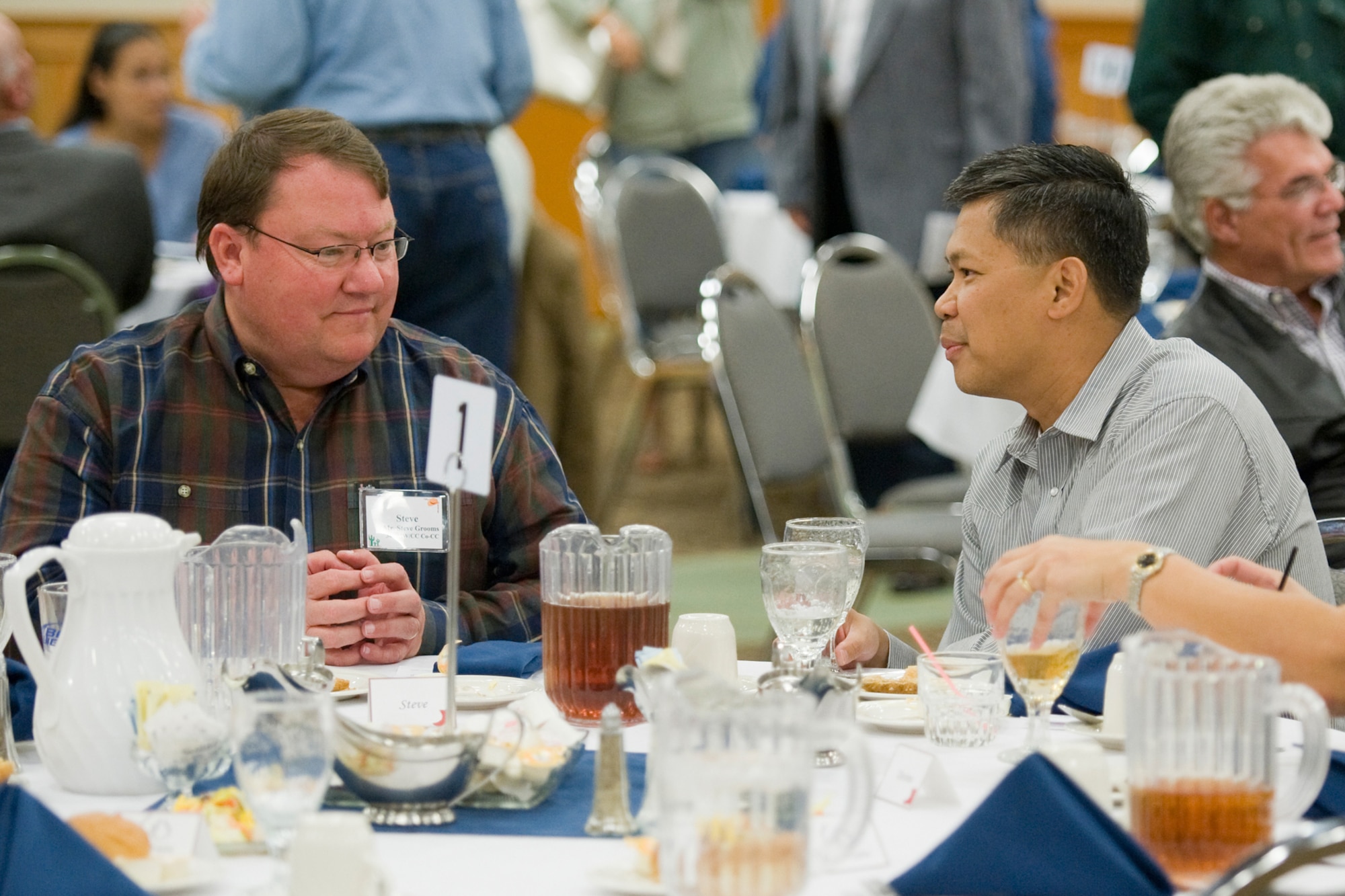 Colonel Brual gets to know his co-commander Steve Grooms a bit better during the Salute to the Community Dinner Sept. 22 at the Grizzly Bend. (U.S. Air Force photo/Beau Wade)