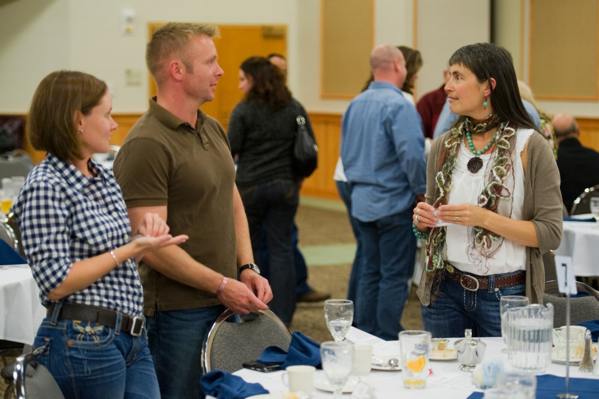 Maj. Walter Sorenson, 341st Security Forces Squadron commander, answers a question from Shawn Green while his wife, Lindsay, listens in. Green is the wife of Mike Green, co-commander to Col. Robert Mendenhall, 341st Security Forces Group commander. (U.S. Air Force photo/Beau Wade)