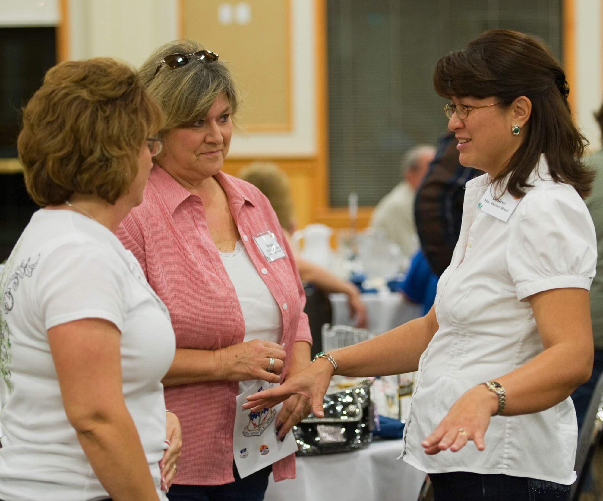 Desiree Brual gets to know Cheryl Ulmer and Bonnie Keller during some predinner conversation. She is the wife of 341st Missile Wing Commander Col. Heraldo Brual. Ulmer is the local representative for Senator Jon Tester and Keller is the representative for Senator Max Baucus. (U.S. Air Force photo/Beau Wade)