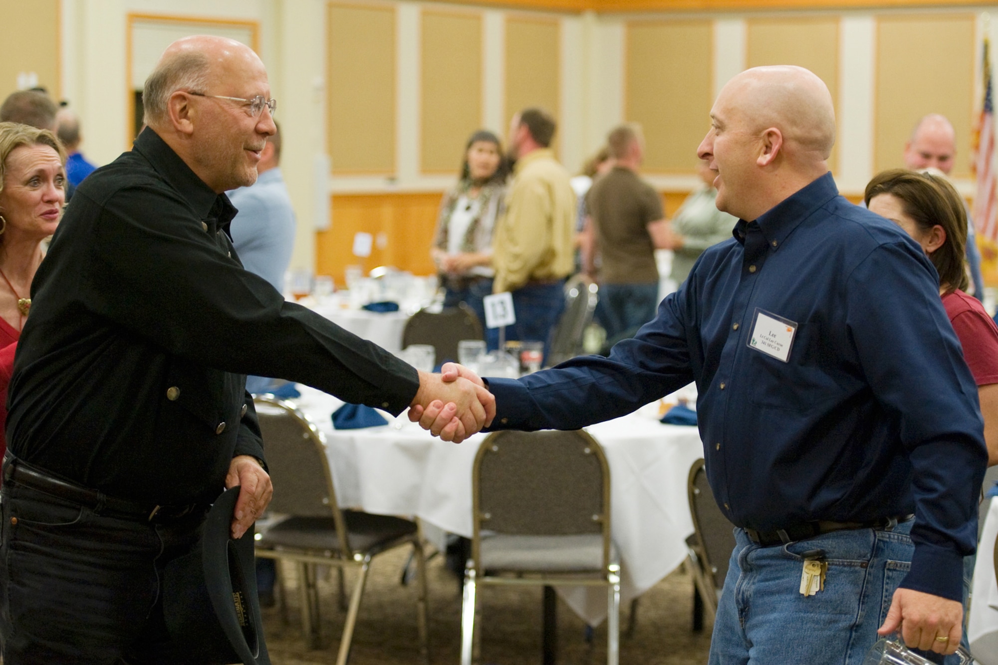 Lt. Col. Lee Curoe, right, greets Don Bisgard and his wife, Kathi, during the social hour prior to the Salute to the Community Dinner Sept. 22. Curoe is the 341st Security Forces Group deputy commander and Bisgard is co-commander of the 341st Security Support Squadron commander. (U.S. Air Force photo/Beau Wade)