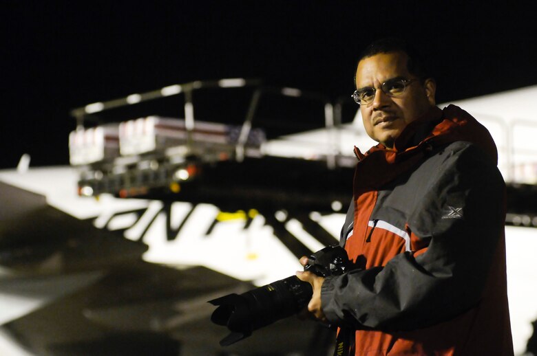 Roland Balik, the senior photographer with the 436th Airlift Wing, is charged with capturing the solemn moments of a dignified transfer Sept. 30, 2011, at Dover Air Force Base, Del. Since the media ban release April 5, 2009, Balik has provided photo support for more than 600 dignified transfers. (Courtesy photo/Steve Ruark)   