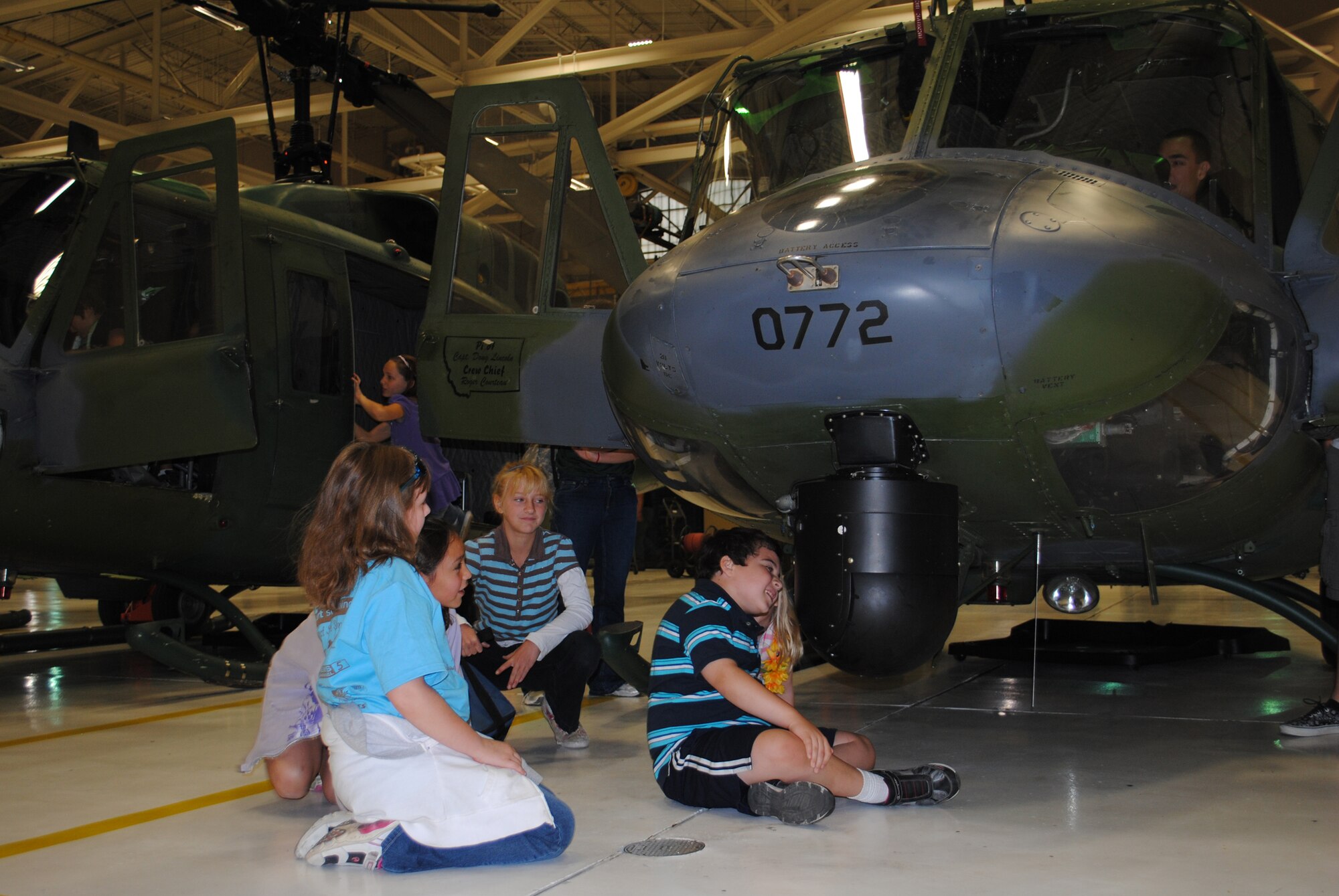 Several children from the Great Falls Big Brothers Big Sisters program watch a spinning camera mounted on the front of one of Malmstrom's UH-1N Huey helicopters during their stop at the 40th Helicopter Squadron on a tour of the base Sept. 24.  (U.S. Air Force photo/Airman Cortney Paxton)
