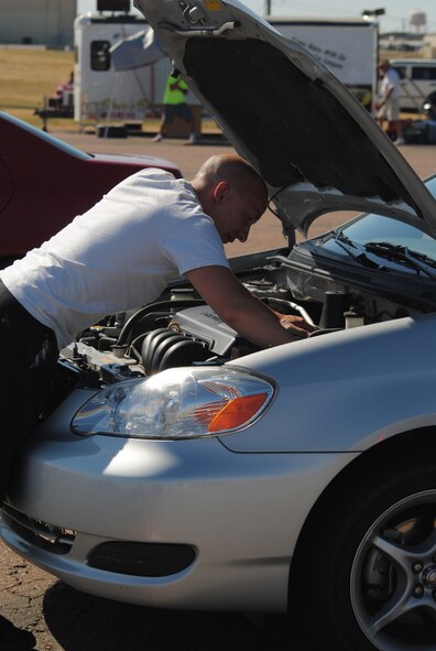 Daniel Damigo, SCCA driver, inspects under the hood of his vehicle prior to racing in the final Sports Car Club of America race Sept. 25. (U.S. Air Force photo/Airman Cortney Paxton)