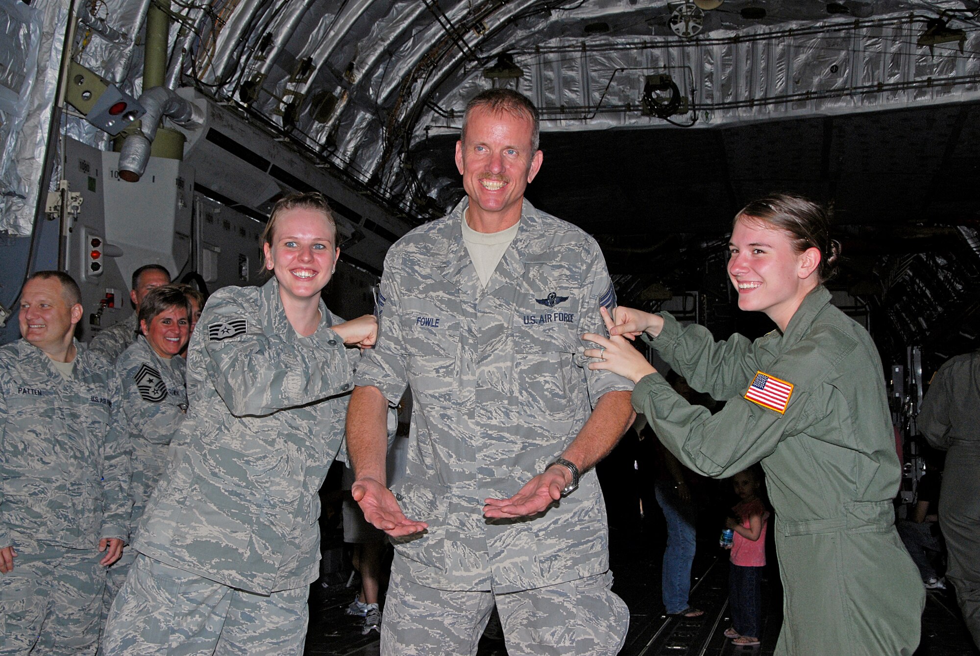 WRIGHT-PATTERSON AIR FORCE BASE, Ohio - Staff Sgt. Brianne Fowle and Senior Airman Brenna Fowle, daughters of Senior Master Sgt. Brian Fowle, congratulate their dad by tacking on his chief stripes.  Fowle was “PEPed” to Chief effective Oct.1. All three are assigned to the 445th Aeromedical Evacuation Squadron. 
The Promotion Enhancement Program is a commander’s program designed to promote outstanding and well-deserving reservists who have clearly demonstrated the potential to serve in the next higher grade over the grade of the billet occupied. (U.S. Air Force photo/Tech. Sgt. Anthony Springer)
