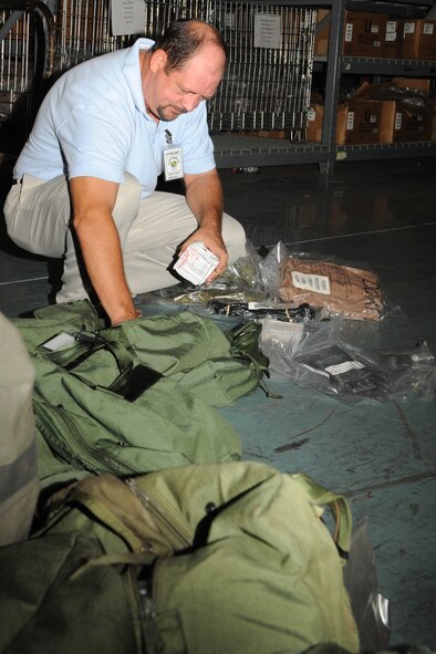 Mark Carper removes items from a chemical bag during a deployment processing line on Seymour Johnson Air Force Base, N.C., Sept. 29, 2011. Carper checks the items against a receipt, verifying that Airmen from the 4th Logistics Readiness Squadron (LRS) individual protective equipment flight provided deployers with the correct equipment. Carper is a 4 LRS quality assurance manager and hails from Princeton, W.Va. (U.S. Air Force photo by Senior Airman Whitney Stanfield)