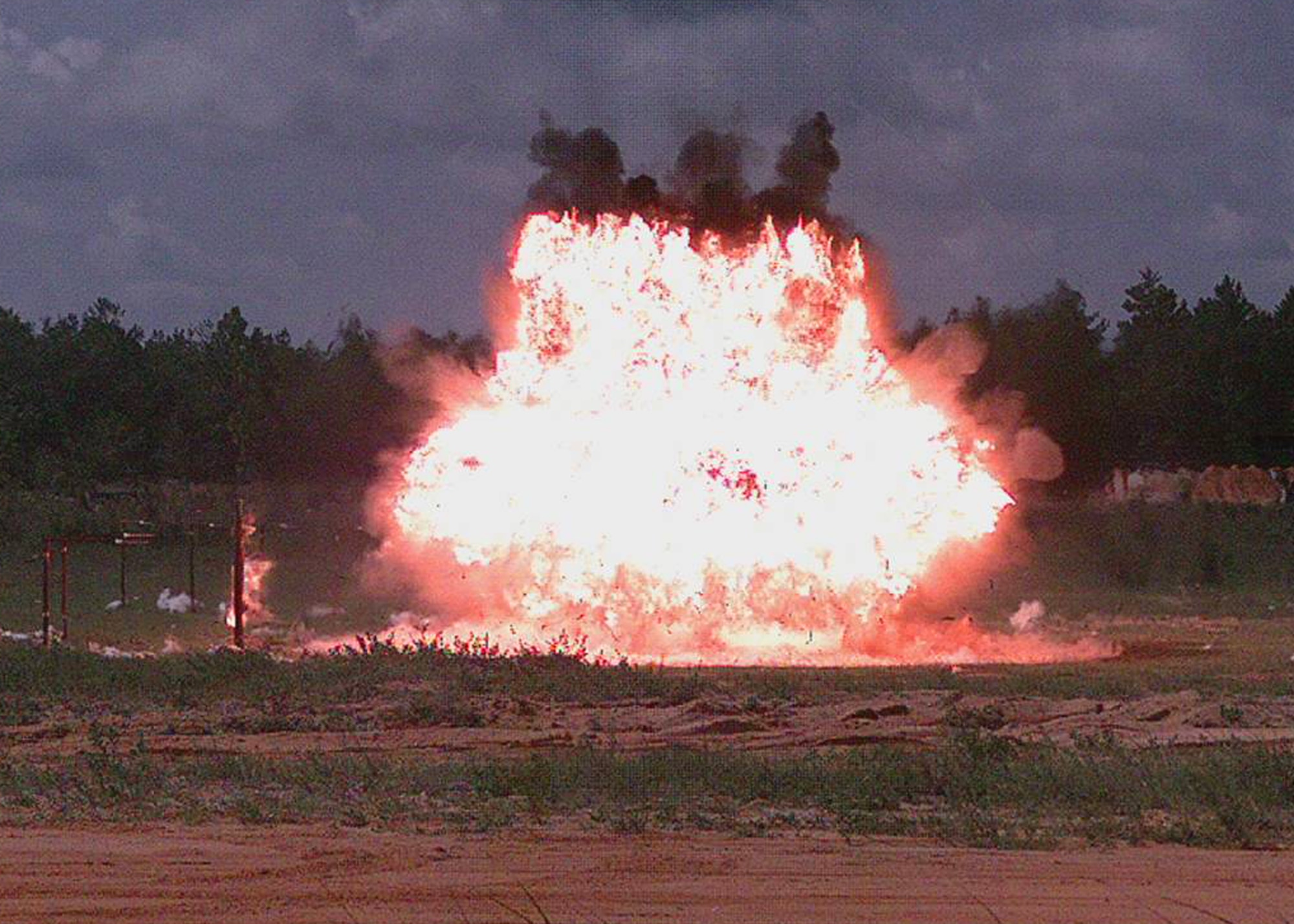 A 40-pound explosive detonates a 60-pound metal cylinder during a recent airblast test by the High Explosives Research and Development facility at Eglin Air Force Base, Fla.  The HERD is the only Air Force facility that develops explosives.  (Courtesy photo)