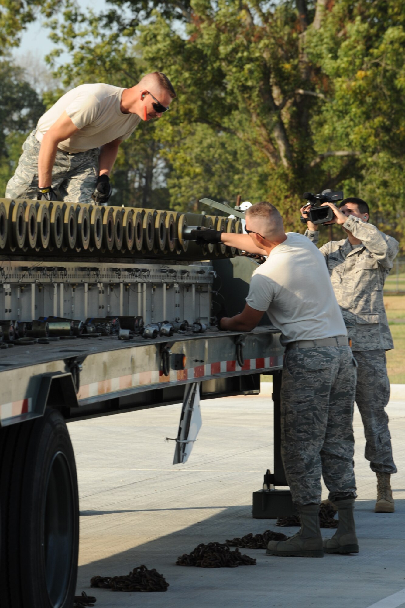 110930-F-PF761-106
U.S. Air Force Senior Airman Anthony Gamez, 3rd Combat Camera Squadron (CCS) videographer, records video of U.S. Air Force Tech. Sgt. Greg Currence and Staff Sgt. Cory Parchman, 307th Maintenance Squadron munitions technicians, as they assemble simulated MK-82, 500 pound general purpose bombs, during a practice bomb-build in preparation for the 2nd annual Global Strike Challenge competition, Barksdale Air Force Base, La., Sept. 30, 2011. The 3rd CCS is tasked with creating video representations of each competition team, which will be shown during the Global Strike Challenge awards ceremony. (U.S. Air Force photo by Master Sgt. Greg Steele/Released)
