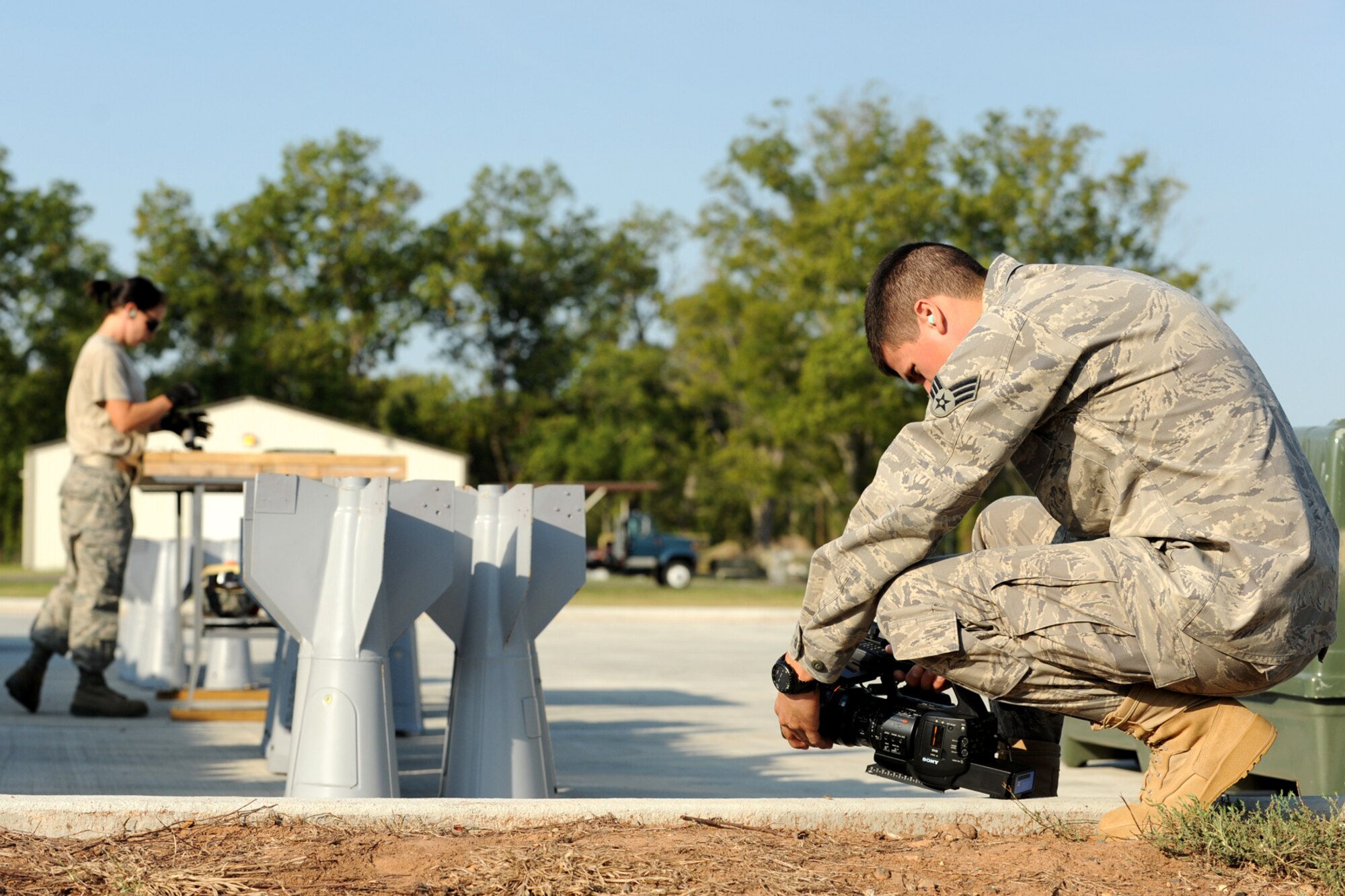 110930-F-PF761-047
U.S. Air Force Senior Airman Anthony Gamez, 3rd Combat Camera Squadron (CCS) videographer, records video of U.S. Air Force Airman 1st Class Teresa Procell, 307th Maintenance Squadron munitions technician, as she participates in a practice bomb-build in preparation for the 2nd annual Global Strike Challenge competition, Barksdale Air Force Base, La., Sept. 30, 2011. The 3rd CCS is tasked with creating video representations of each competition team, which will be shown during the Global Strike Challenge awards ceremony. (U.S. Air Force photo by Master Sgt. Greg Steele/Released)
