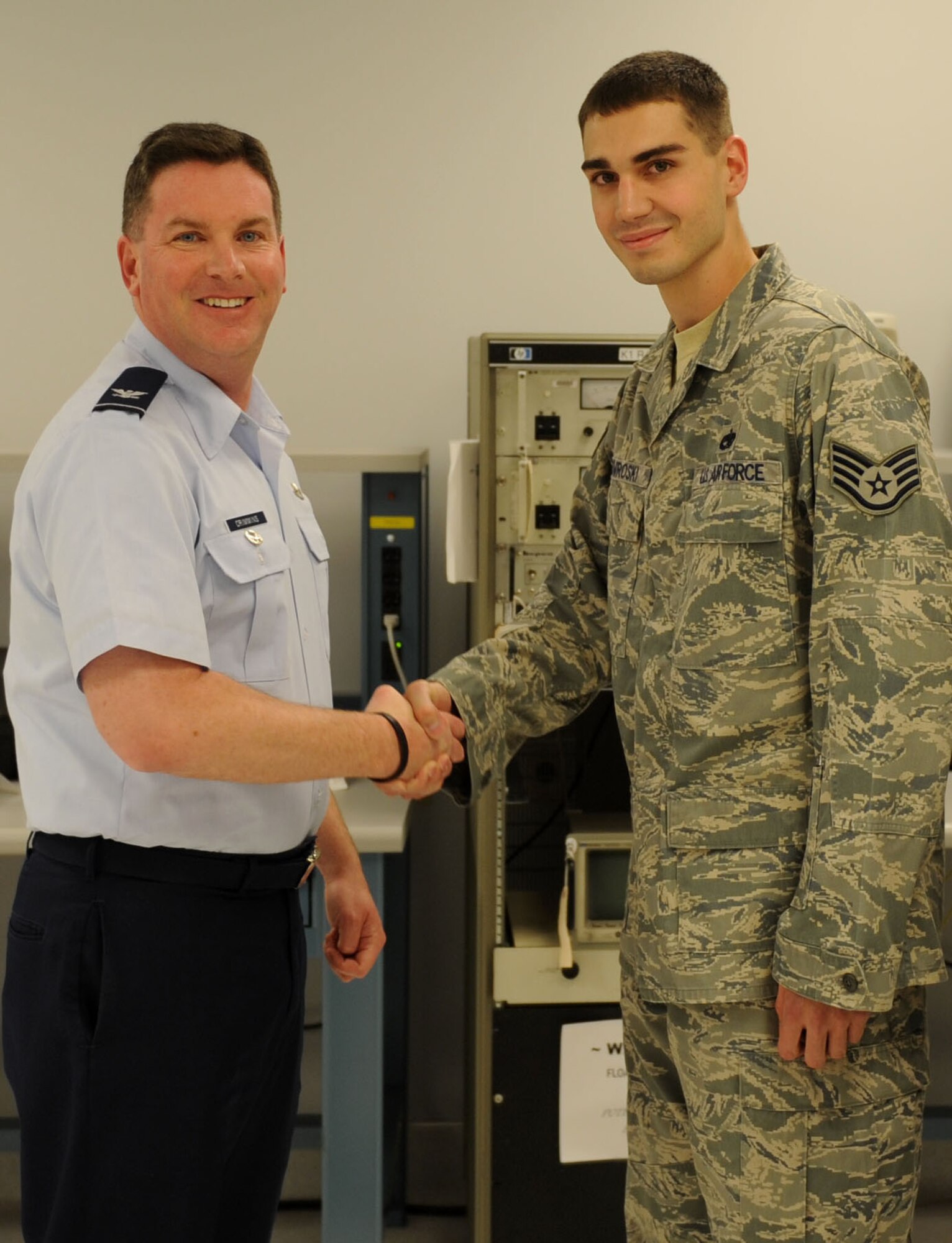 Col. Thomas Crimmins, 19th Airlift Wing vice commander, presents a commander’s coin to Staff Sgt. Richard Nowroski, 19th Component Maintenance Squadron precision measurement equipment laboratory quality manager, native to Mount Carmel, Penn., Sept. 19, 2011, at Little Rock Air Force Base, Ark. Nowroski lead the way in completing 180 calibrations, including three priorities with a 100-percent quality rating and was chosen to be flight’s quality manager. (U.S. Air Force photo by Senior Airman Caleb Pierce)