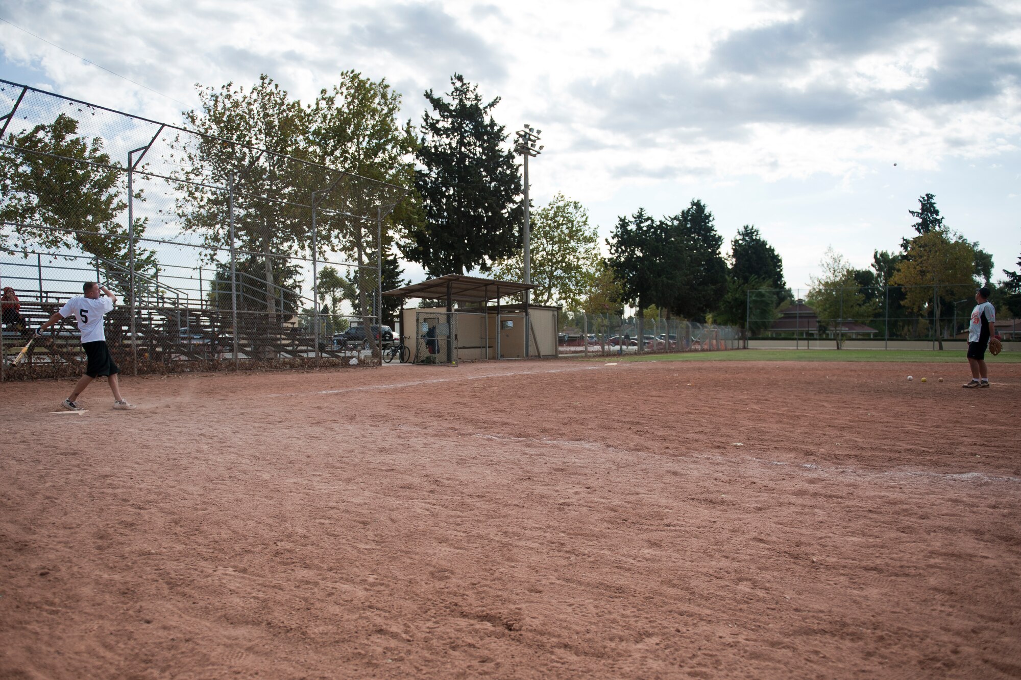 Tech. Sgt. Kris Auger, 39th Medical Operations Squadron, left, hits a softball pitch by Tech. Sgt. Tim Davis, 39th Logistics Readiness Squadron, during the home run derby portion of the National Breast Cancer Awareness Month event Oct. 1, 2011, at Arkadas Park at Incirlik Air Base, Turkey. The event was sponsored by the Health and Wellness Center, fitness center and women's health clinic to raise breast cancer awareness and money for a donation to the Susan G. Komen For the Cure Foundation. (U.S. Air Force photo by Tech. Sgt. Michael B. Keller/Released)