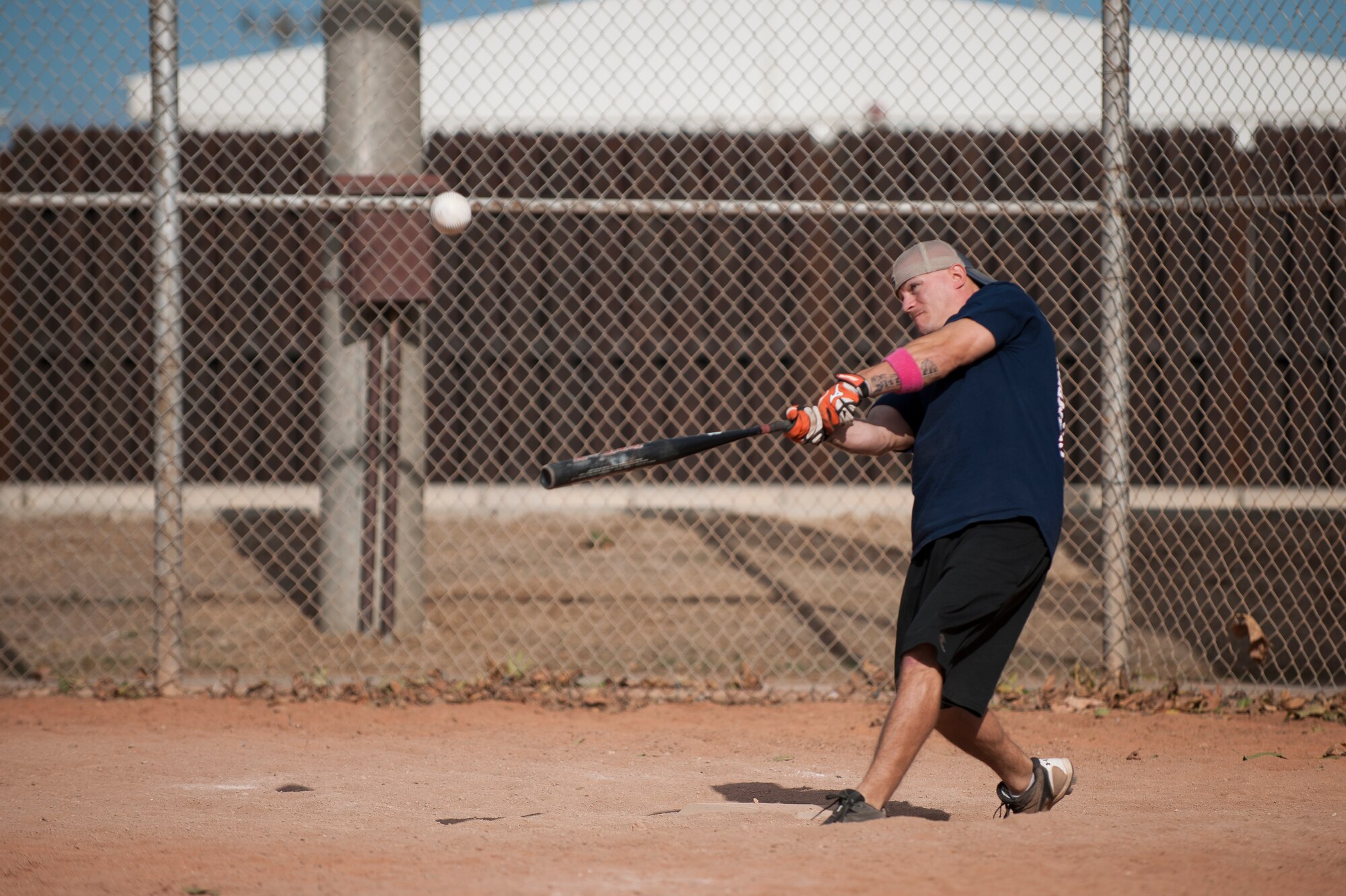 Tech. Sgt. Chad Ashton, 39th Logistics Readiness Squadron, hits a softball during the home run derby portion of the National Breast Cancer Awareness Month event Oct. 1, 2011, at Arkadas Park at Incirlik Air Base, Turkey. The event was sponsored by the Health and Wellness Center, fitness center and women's health clinic to raise breast cancer awareness and money for a donation to the Susan G. Komen For the Cure Foundation. (U.S. Air Force photo by Tech. Sgt. Michael B. Keller/Released)