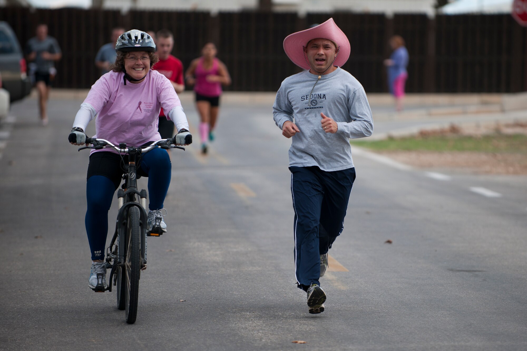 Lt. Col. Tonney Kaw-Uh, 39th Air Base Wing inspector general, right, and his wife, Teresa, finish the 5K portion of the National Breast Cancer Awareness Month event Oct. 1, 2011, at Arkadas Park at Incirlik Air Base, Turkey. The event was sponsored by the Health and Wellness Center, fitness center and women's health clinic to raise breast cancer awareness and money for a donation to the Susan G. Komen For the Cure Foundation. (U.S. Air Force photo by Tech. Sgt. Michael B. Keller/Released)