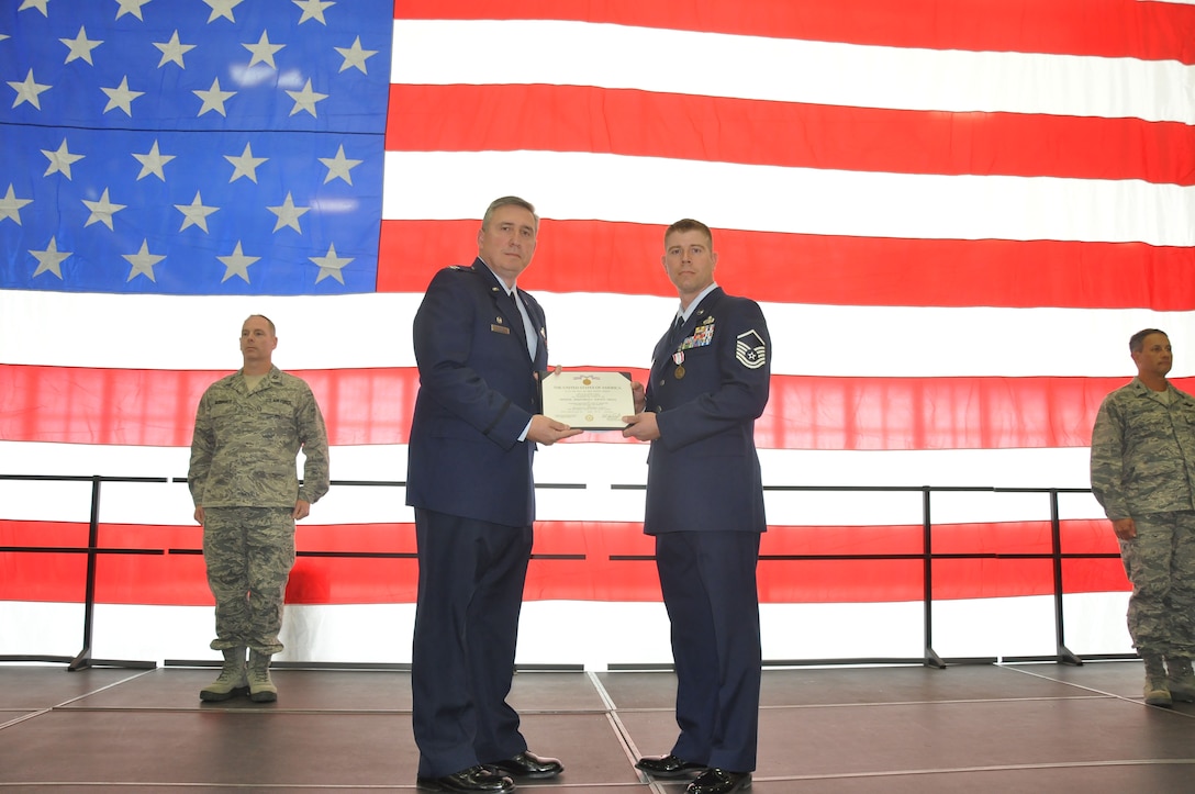 U.S. Air Force Master Sgt. Cory DeMuth (right) receives the Defense Meritorious Service Medal and Army Commendation Medal from Col. Darrell Young, 934th Airlift Wing Commander, Oct. 2 for his life saving efforts in Iraq. (Air Force photo/TSgt. Bob Sommer)