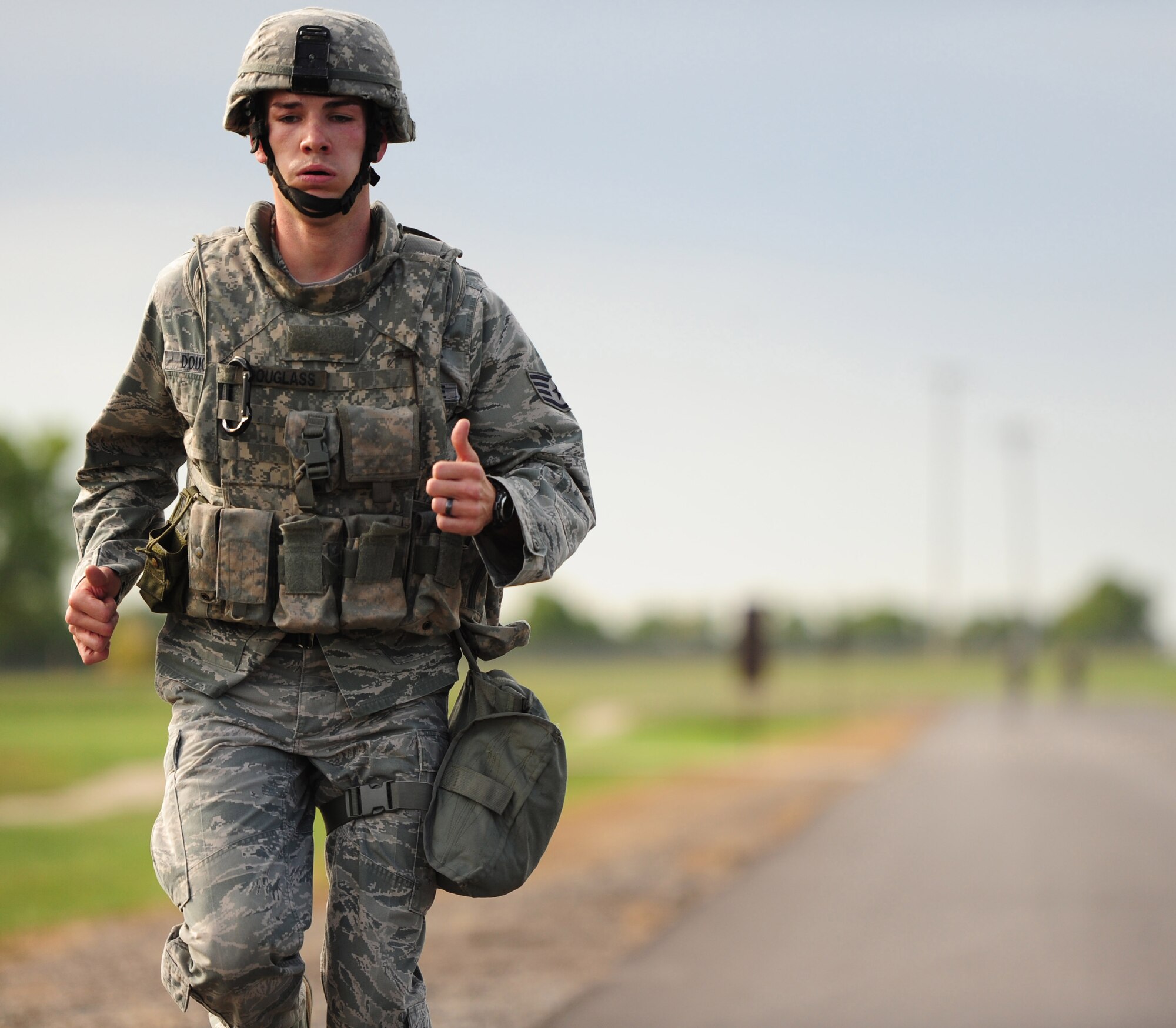 Staff Sgt. Kyle Douglass,  509th Security Forces Squadron, competes in the running portion of the Air Force Global Strike Command Challenge try-outs here Sept. 21. Participants ran almost two miles with and without gas masks while wearing Kevlar helmets and vests. (U.S. Air Force photo/Senior Airman Nick Wilson) (RELEASED)