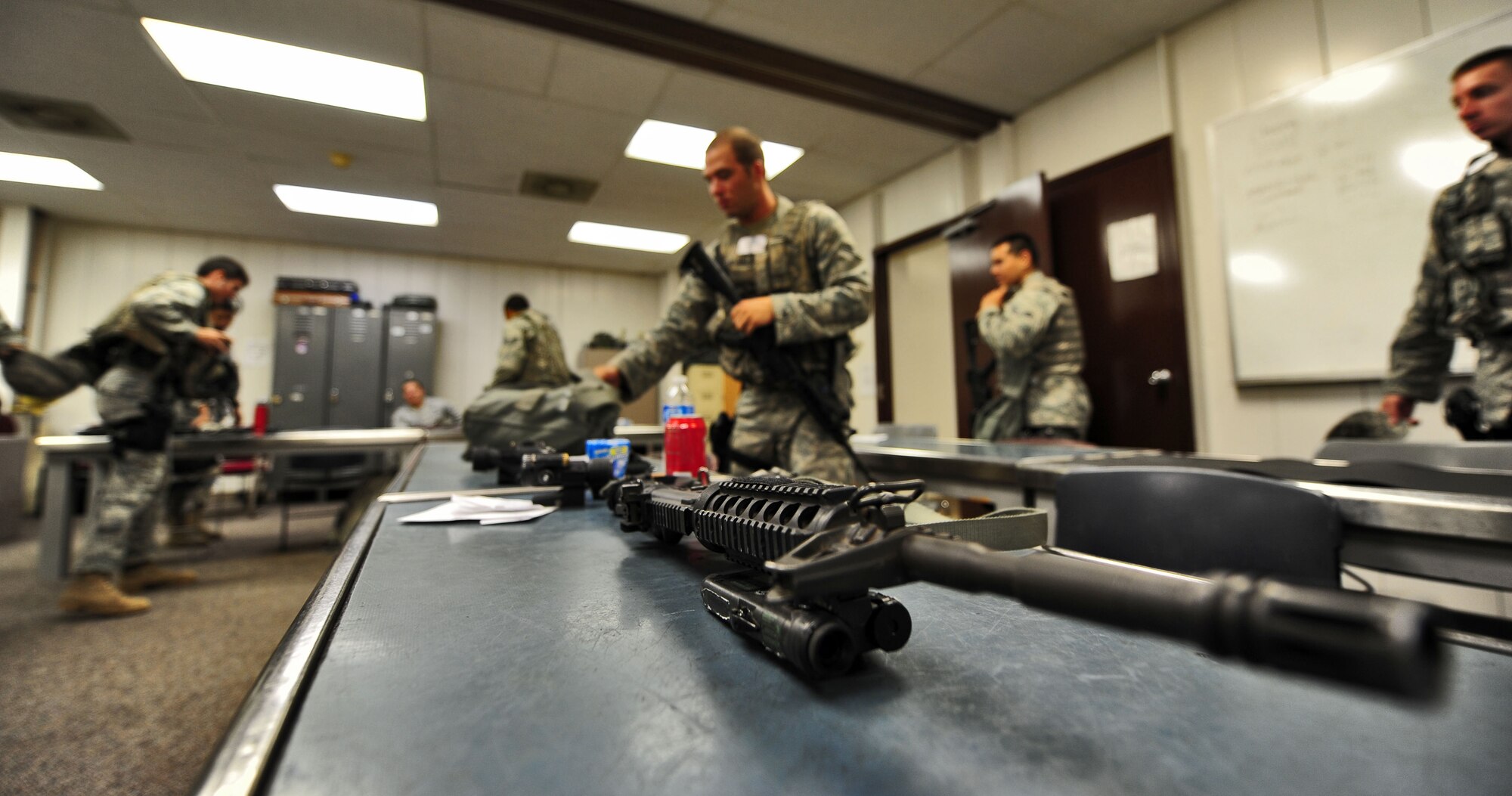 Airmen from the 509th Security Forces Squadron gather equipment before participating in the combat arms portion of the Air Force Global Strike Command Challenge try-outs here Sept 21.  Of those competing, seven will be placed on the challenge team to represent Whiteman Air Force Base at the Global Strike Challenge in November at Barksdale Air Force Base, La. (U.S. Air Force photo/Senior Airman Nick Wilson)