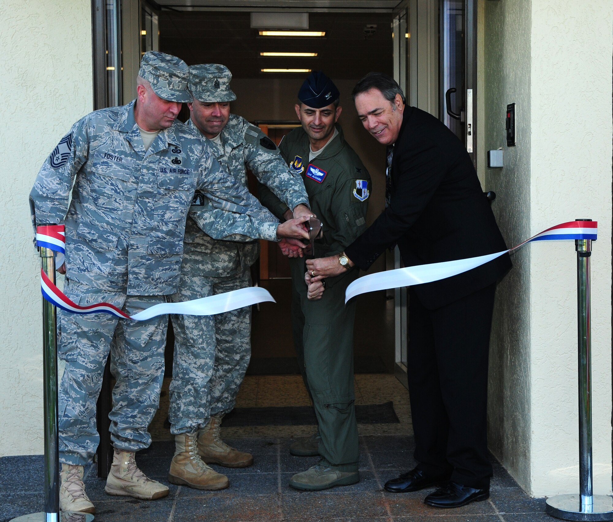 SPANGDAHLEM AIR BASE, Germany – From left to right, U.S. Air Force Chief Master Sgt. Tyler Foster, American Forces Network Europe operations chief; U.S. Army Command Sgt. Maj. John Brenci, AFN Europe command sergeant major; U.S. Air Force Col. David Julazadeh, 52nd Fighter Wing vice commander; and Mark Vagnerini, AFN Europe deputy director, cut a ribbon to officially open the new AFN building during a ceremony here Sept. 30. The ceremony represented the end of the AFN Spangdahlem’s office move from Bitburg Annex to a new facility on Spangdahlem AB. (U.S. Air Force photo/Airman 1st Class Matthew B. Fredericks)
