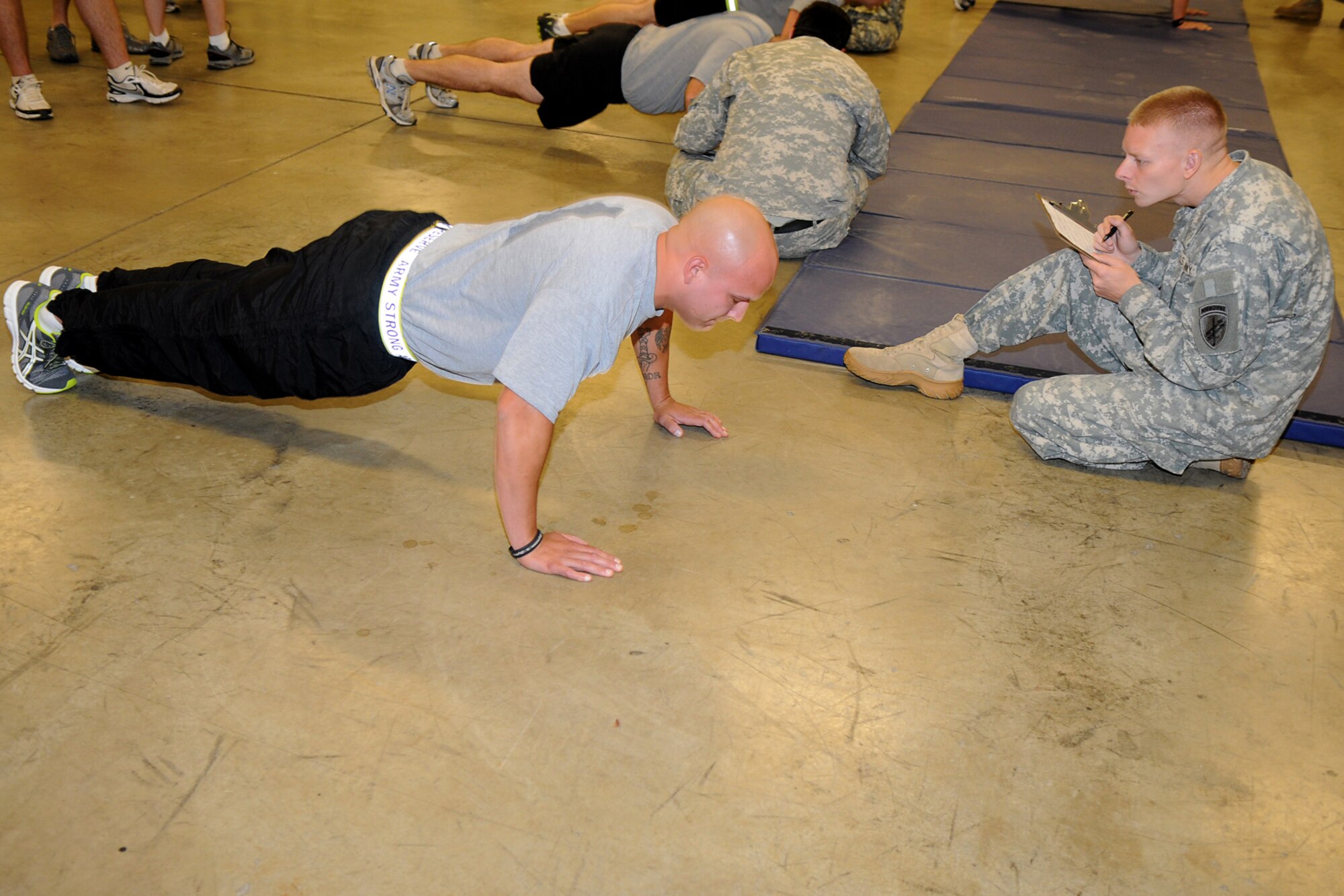 GRISSOM AIR RESERVE BASE, Ind. -- Staff Sgt. Christopher Deisler, 316th Tactical Psychological Operations Company, pumps out the push-ups as Sgt. Adrian Osman, 316th Tactical Psychological Operations Company multi-media technician, counts each rep closely during the physical assessment test. The PT test was just one of the events that took place during the 2nd annual PSYOP Stakes Sept. 16. The Soldiers took part in the two-day event to assess their strengths and weaknesses in various areas. (U.S. Air Force photo/Senior Airman Jami K. Lancette)