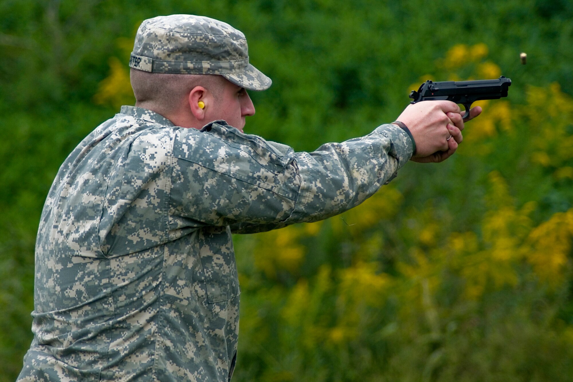 GRISSOM AIR RESERVE BASE, Ind. -- Spc. Nathan Carter, 316th Tactical Psychological Operations Company, aims an M-9 pistol at a target during the 2nd annual PSYOP Stakes Sept. 16. The shooting range was just one of the events that took place during the stakes. The Soldiers took part in the two-day event to assess their strengths and weaknesses in various areas. (U.S. Air Force photo/Senior Airman Jami K. Lancette)