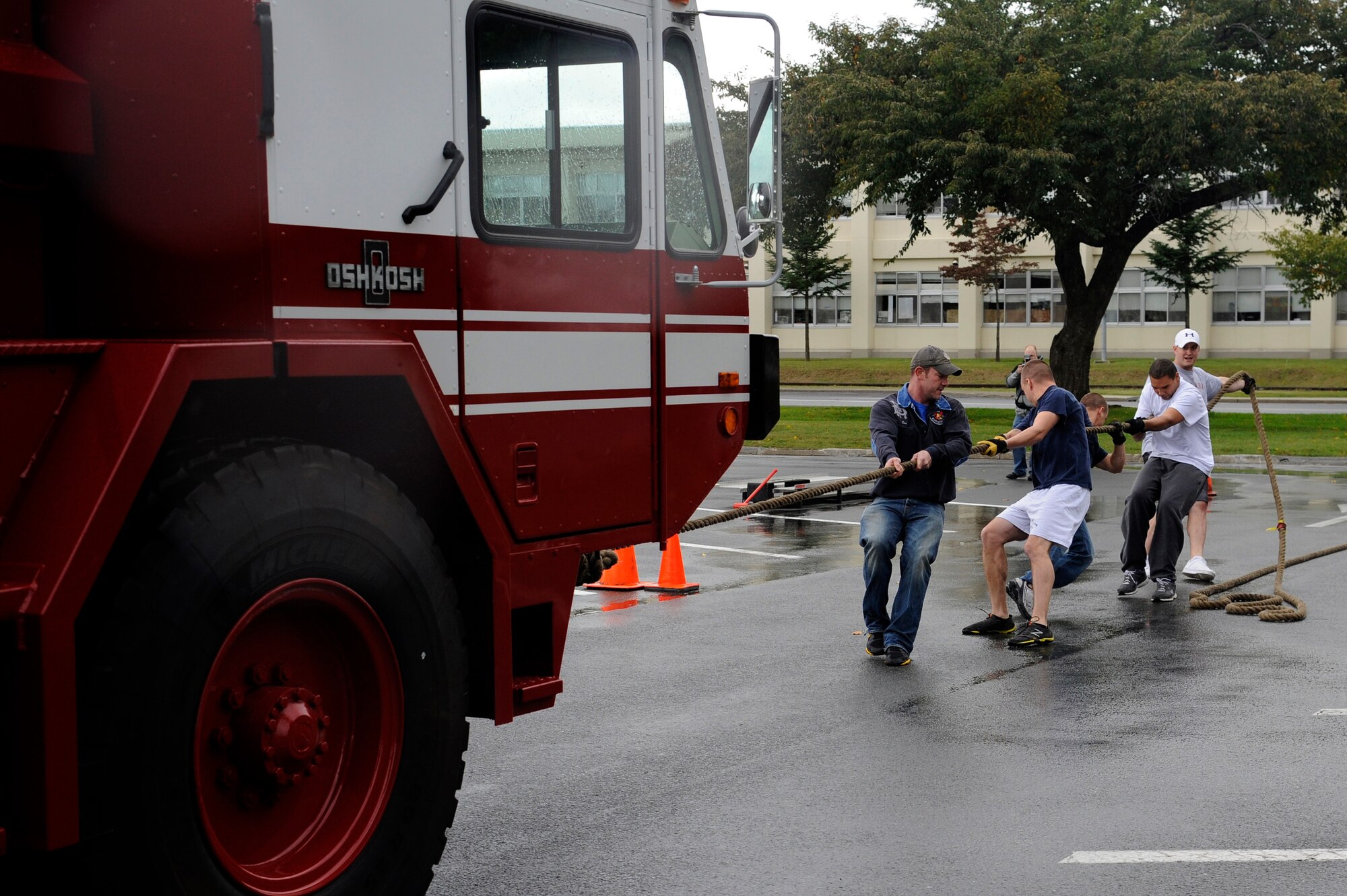 MISAWA AIR BASE, Japan - Members of the 35th Civil Engineer Squadron pull a fire truck weighing more than 34,000 pounds during the fire muster competition held at the base exchange parking lot here Oct. 2. Firefighters from the 35 CES along with firefighters from Misawa City and Towada City participated in a fire muster to kick off Fire Prevention Week. Fire Prevention Week was established to commemorate the Great Chicago Fire, the tragic 1871 blaze that killed more than 250 people, left 100,000 homeless, destroyed more than 17,400 structures and burned more than 2,000 acres. In 1920, President Woodrow Wilson issued the first National Fire Prevention Day proclamation, and since 1922, Fire Prevention Week has been observed on the Sunday through Saturday period in which October 9 falls. (U.S. Air Force photo/Tech. Sgt. Marie Brown)
