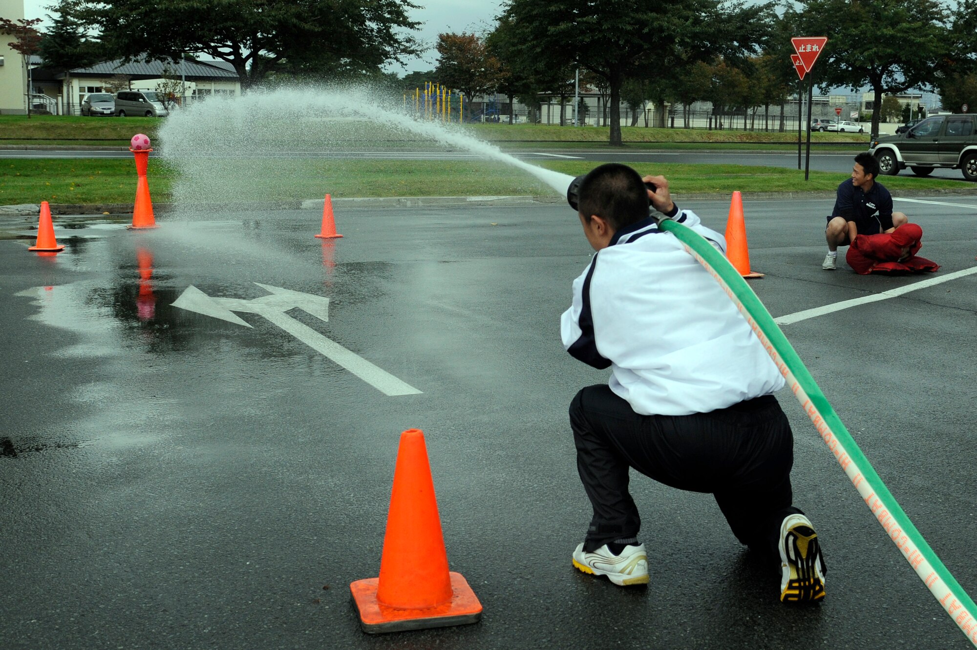 MISAWA AIR BASE, Japan - A local Japanese firefighter tries to knock a ball off a traffic cone during the combat challenge relay race in the base exchange parking lot here Oct. 2. Firefighters from the 35th Civil Engineer Squadron along with firefighters from Misawa City and Towada City participated in a fire muster to kick off Fire Prevention Week. Fire Prevention Week was established to commemorate the Great Chicago Fire, the tragic 1871 blaze that killed more than 250 people, left 100,000 homeless, destroyed more than 17,400 structures and burned more than 2,000 acres. In 1920, President Woodrow Wilson issued the first National Fire Prevention Day proclamation, and since 1922, Fire Prevention Week has been observed on the Sunday through Saturday period in which October 9 falls. (U.S. Air Force photo/Tech. Sgt. Marie Brown)