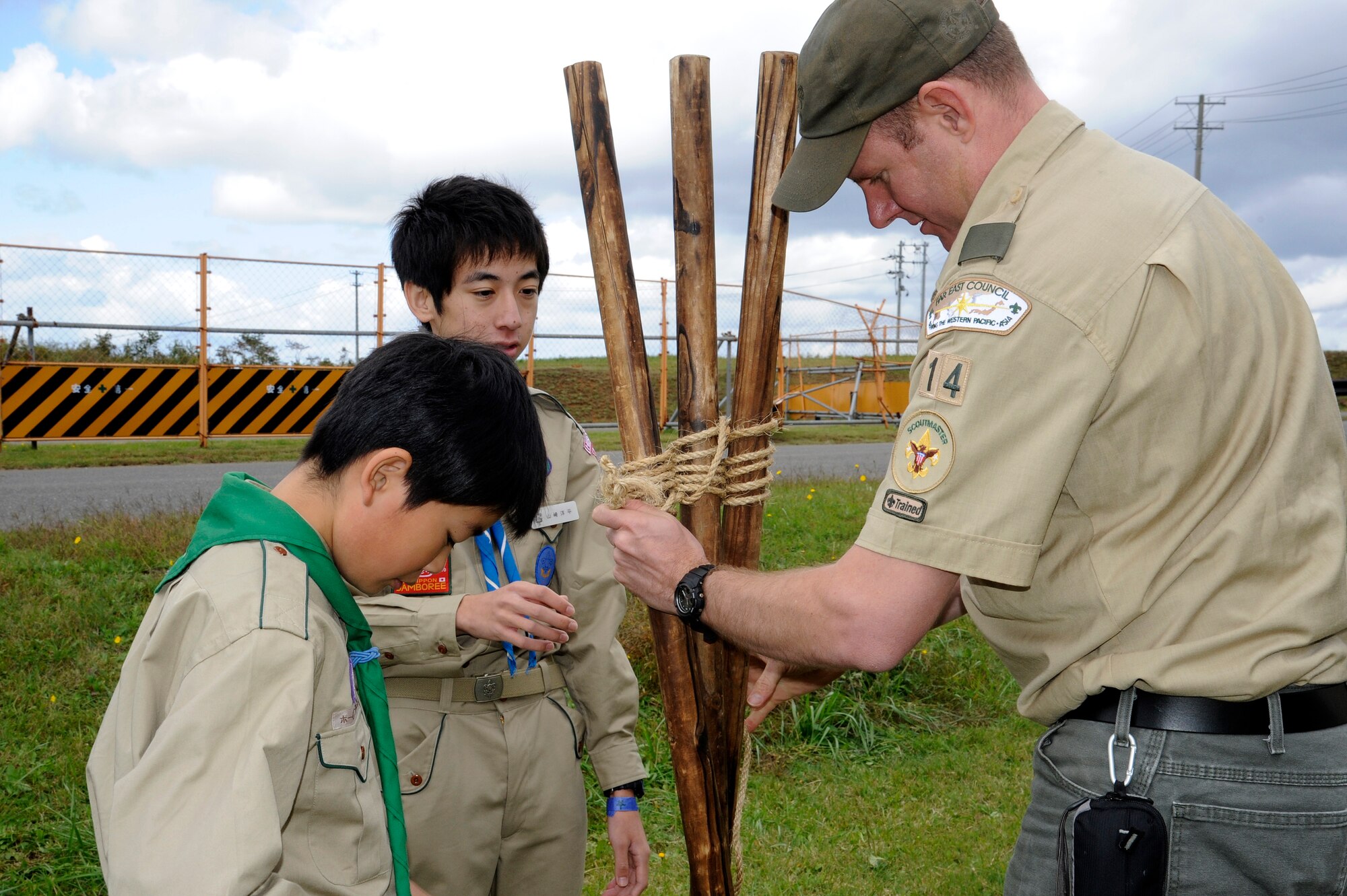 MISAWA AIR BASE, Japan - Justin Kandle, Scoutmaster troop 14, helps local national Japanese Boy Scouts assemble a tripod during International Scout Day at a Hangar here Oct. 1.International Scout Day is a local celebration of bilateral friendships and cooperation. Japanese and U.S. Scouts have annually gathered at Misawa Air Base since 1959, but the first official International Scout Day occurred in 1992. More than 200 Boy and Girl Scouts from Misawa Air Base and more than 300 Japanese Boy and Girl Scouts attended this year’s event. (U.S. Air Force photo/Tech. Sgt. Marie Brown)