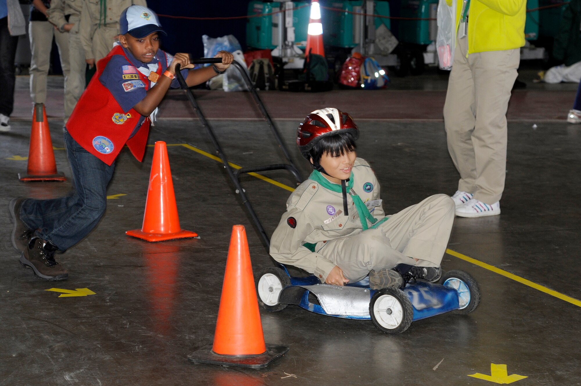 MISAWA AIR BASE, Japan - Taj Lee, left, son of Capt. Darrick Lee, 35th Fighter Wing, pushes a local Japanese Boy Scout on a lawn mower through an obstacle course during International Scout Day at a Hangar here Oct. 1. International Scout Day is a local celebration of bilateral friendships and cooperation. Japanese and U.S. Scouts have annually gathered at Misawa Air Base since 1959, but the first official International Scout Day occurred in 1992. More than 200 Boy and Girl Scouts from Misawa Air Base and more than 300 Japanese Boy and Girl Scouts attended this year’s event. (U.S. Air Force photo/Tech. Sgt. Marie Brown)