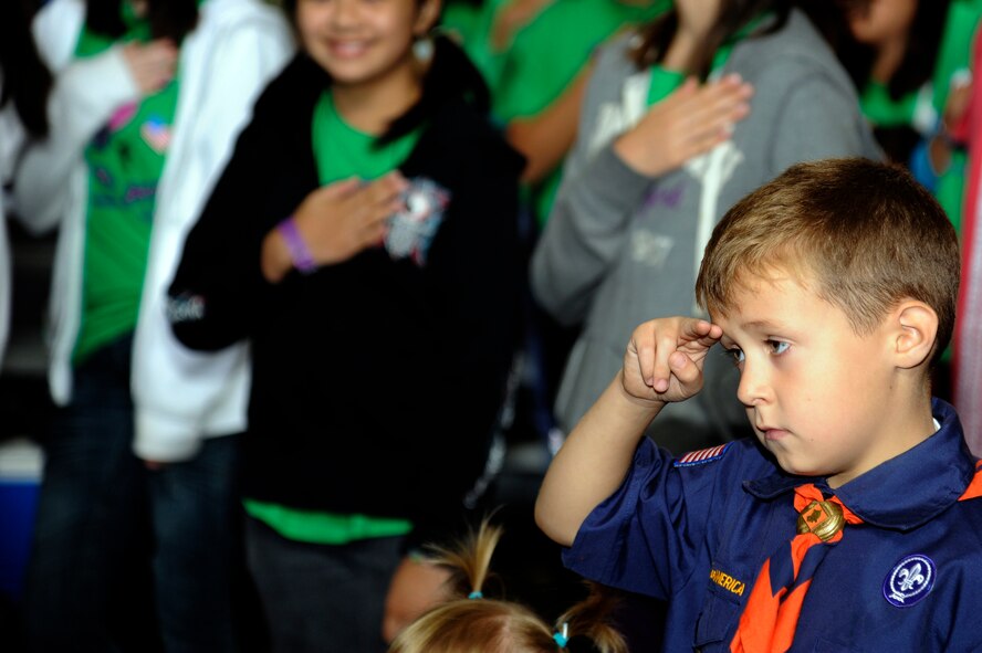 Bryce Smith, Tiger Cub Scout, son of Staff Sgt. Mark Dumas, 35th Aircraft Maintenance Squadron, salutes during the playing of the U.S. and Japanese National Anthems during International Scout Day at a Hangar, Misawa Air Base, Japan, Oct. 1. International Scout Day is a local celebration of bilateral friendships and cooperation. Japanese and U.S. Scouts have annually gathered at Misawa Air Base since 1959, but the first official International Scout Day occurred in 1992. More than 200 Boy and Girl Scouts from Misawa Air Base and more than 300 Japanese Boy and Girl Scouts attended this year’s event. (U.S. Air Force photo/Tech. Sgt. Marie Brown) 
