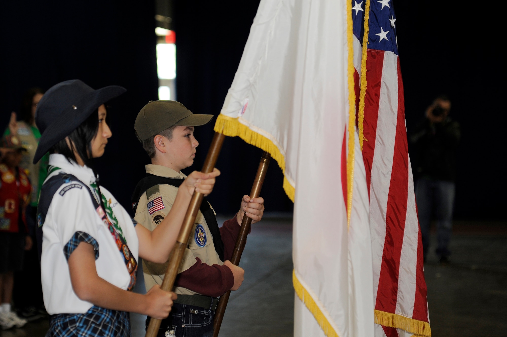 MISAWA AIR BASE, Japan - Miku Saito, left, senior scout of Aomori-ken Hirosaki Girl Scout Troop nine and Shawn Singleton, Boy Scout Troop 14, presents the colors during the International Scout Day at a Hangar here Oct. 1. International Scout Day is a local celebration of bilateral friendships and cooperation. Japanese and U.S. Scouts have annually gathered at Misawa Air Base since 1959, but the first official International Scout Day occurred in 1992. More than 200 Boy and Girl Scouts from Misawa Air Base and more than 300 Japanese Boy and Girl Scouts attended this year’s event. (U.S. Air Force photo/Tech. Sgt. Marie Brown)