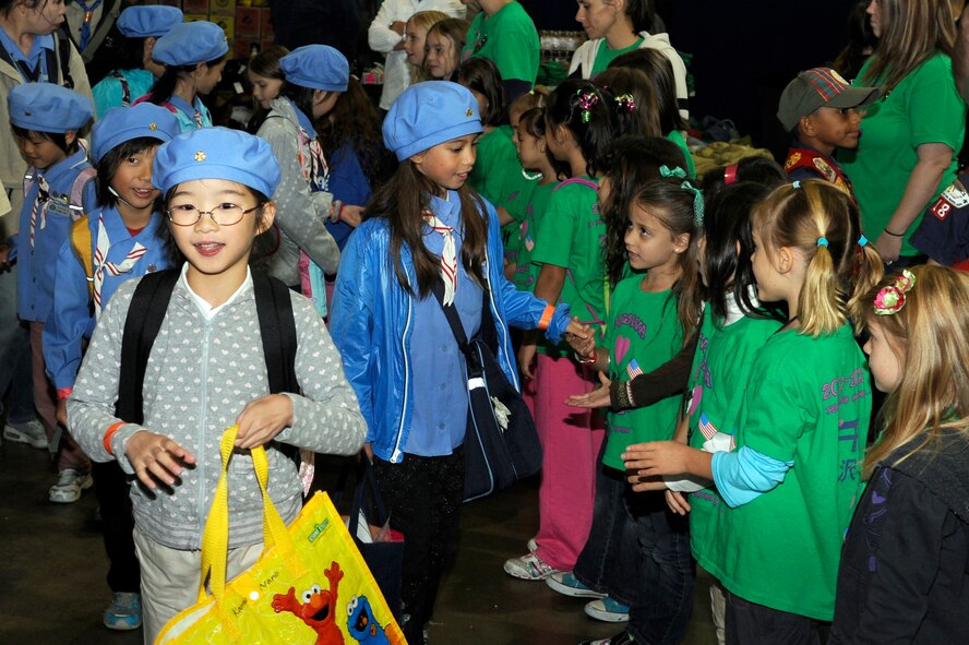 American Girl Scouts welcome Japanese Girl Scouts to International Scout Day at a Hangar, Misawa Air Base, Japan, Oct. 1. International Scout Day is a local celebration of bilateral friendships and cooperation. Japanese and U.S. Scouts have annually gathered at Misawa Air Base since 1959, but the first official International Scout Day occurred in 1992. More than 200 Boy and Girl Scouts from Misawa Air Base and more than 300 Japanese Boy and Girl Scouts attended this year’s event. (U.S. Air Force photo/Tech. Sgt. Marie Brown) 
