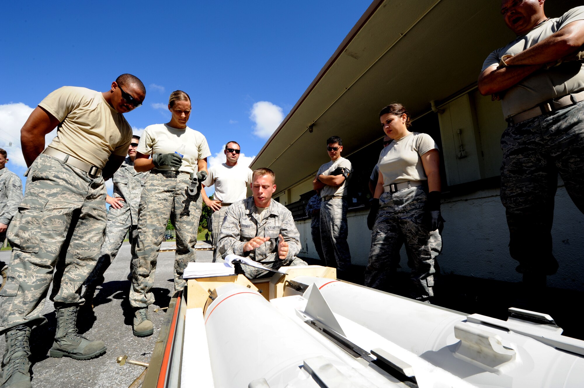 United States Air Force Staff Sgt. Brandon Thomas, 18th Munitions Squadron precision guided munitions inspector, briefs wing leadership on the shipping process for tactical air munitions rapid response package during an orientation in the munitions area on Kadena Air Base, Japan, Sept. 30. Commanders and leaders from the base were given the opportunity to learn what a typical ammo troop operates during an exercise. (U.S. Air Force photo/Airman 1st Class Jarvie Z. Wallace)