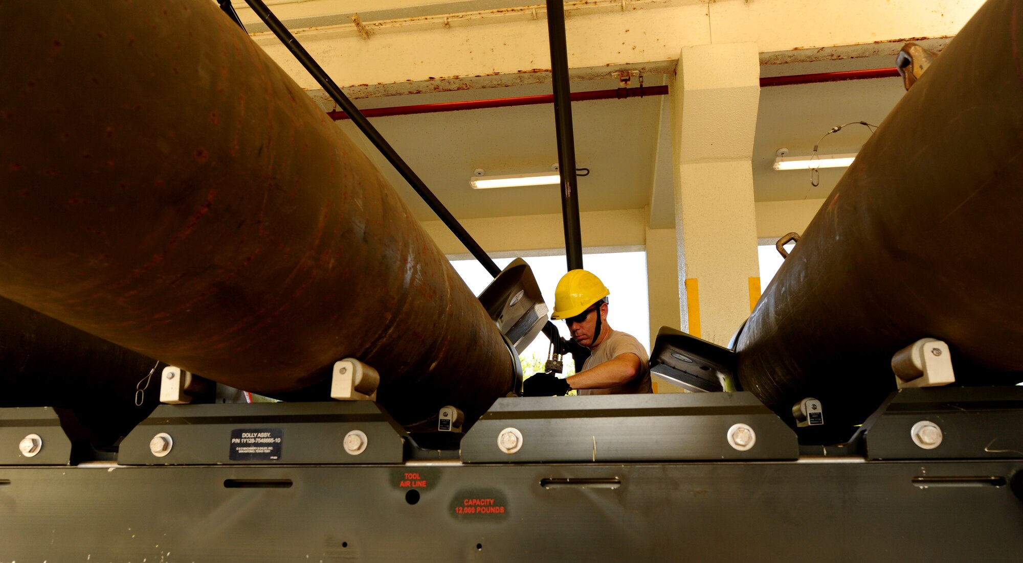 United States Air Force Maj. Stephen Harvey, 18th Equipment Maintenance Squadron commander, bolts parts together while creating bombs in the munitions area on Kadena Air Base, Japan, Sept. 30. This orientation gave an opportunity for wing leadership to get hands-on experience of what the typical munitions Airman does when tasked to build munitions. (U.S. Air Force photo/Airman 1st Class Jarvie Z. Wallace)   