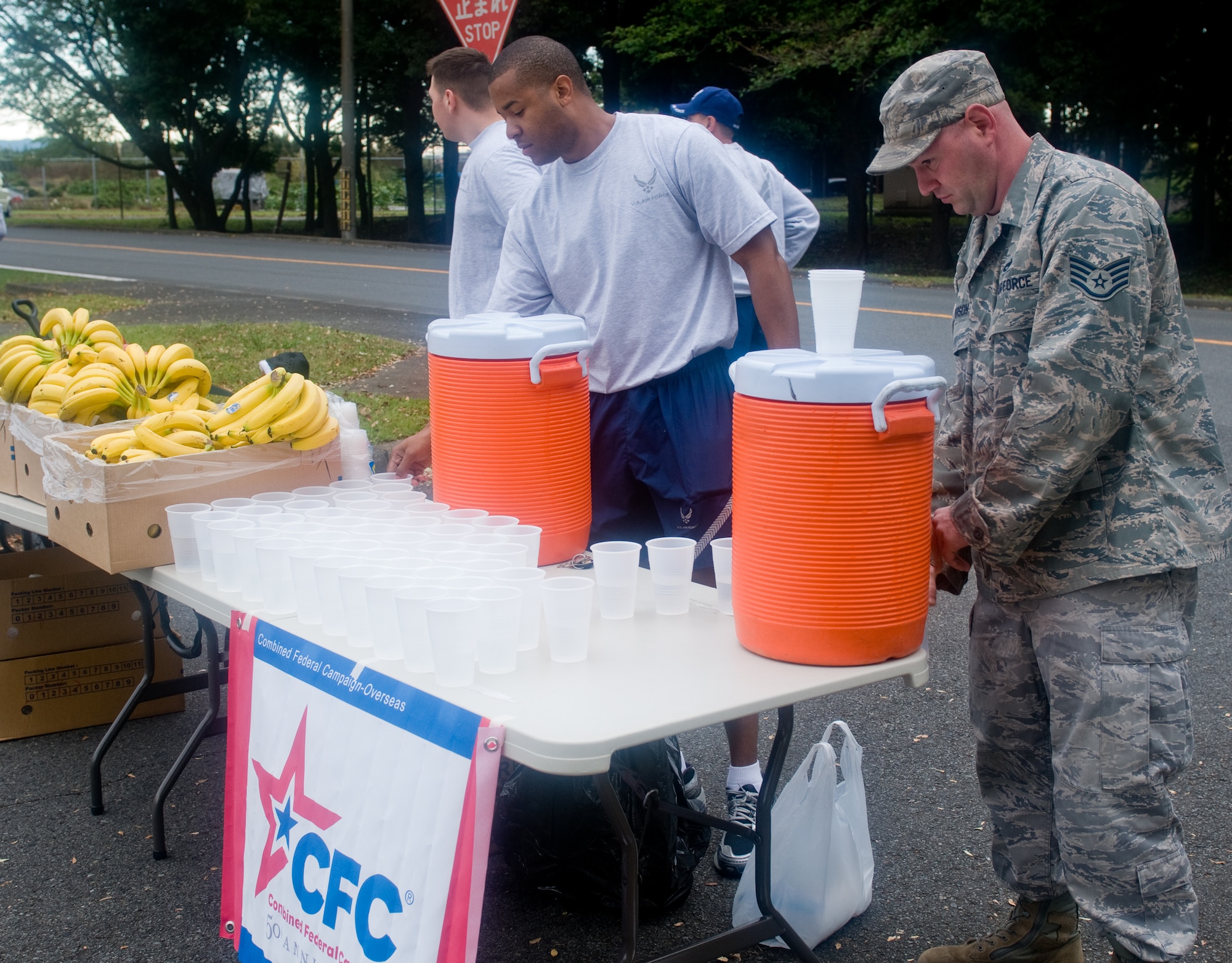 YOKOTA AIR BASE, Japan -- Volunteers set up fruit and water for participants during the Combined Federal Campaign 5k run at Yokota Air Base, Japan, Oct. 3, 2011. This is the 50th year anniversary for the CFC, which raises money for more than 2,400 charitable organizations. (U.S. Air Force photo/Airman 1st Class Krystal M. Garrett) 