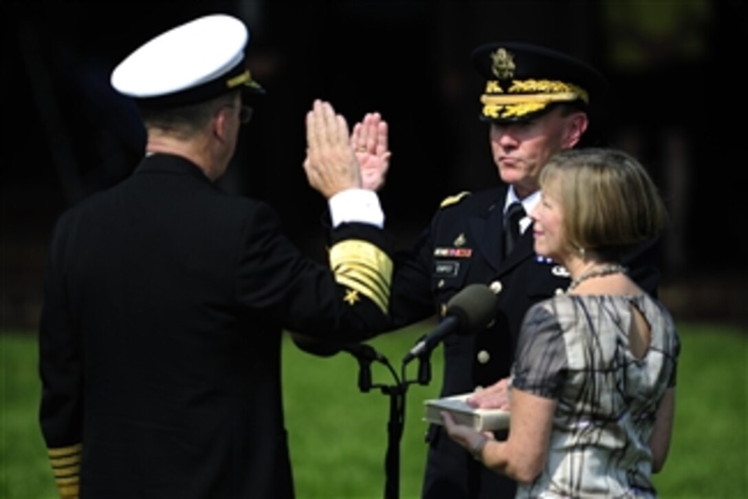 Outgoing Chairman of the Joint Chiefs of Staff Adm. Mike Mullen, left, administers the oath of office to Army. Gen. Martin E. Dempsey, as the 18th chairman of the Joint Chiefs of Staff during the change of responsibility ceremony at Summerall Field, Joint Base Myer-Henderson Hall, Va., on Sept. 30, 2011. 