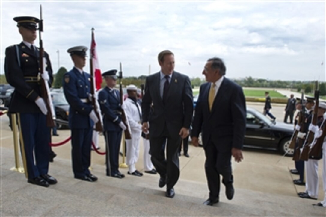 Secretary of Defense Leon E. Panetta, right, escorts Canadian Minister of Defense Peter MacKay through an honor cordon and into the Pentagon in Arlington, Va., on Sept.30, 2011.  Panetta and Mackay will meet to discuss security matters of mutual interest.  