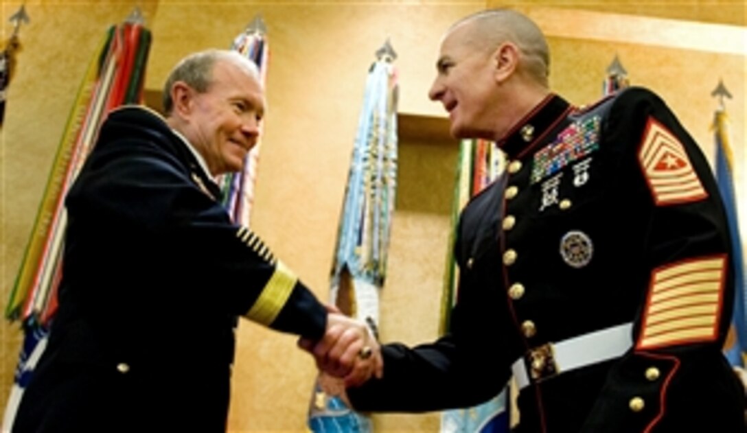 Army Gen. Martin E. Dempsey, chairman of the Joint Chiefs of Staff, and Marine Corps Sgt. Maj. Bryan B. Battaglia shake hands at the conclusion of the senior enlisted advisor swearing-in ceremony on Joint Base Myer-Henderson Hall, Va., Sept. 30, 2011.