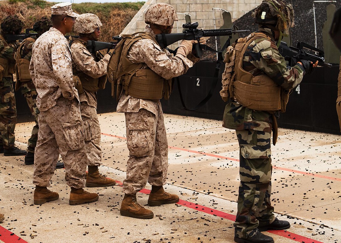 French airborne soldiers and Marines from 2nd Battalion, 3rd Marine Regiment, conduct combat marksmanship program training at a range here Oct. 4 during Exercise AMERCAL 2011. The purpose of the exercise was to enhance interoperability, improve military-to-military relations and sharpen warfighting skills through a combined training exchange with the NATO ally.
